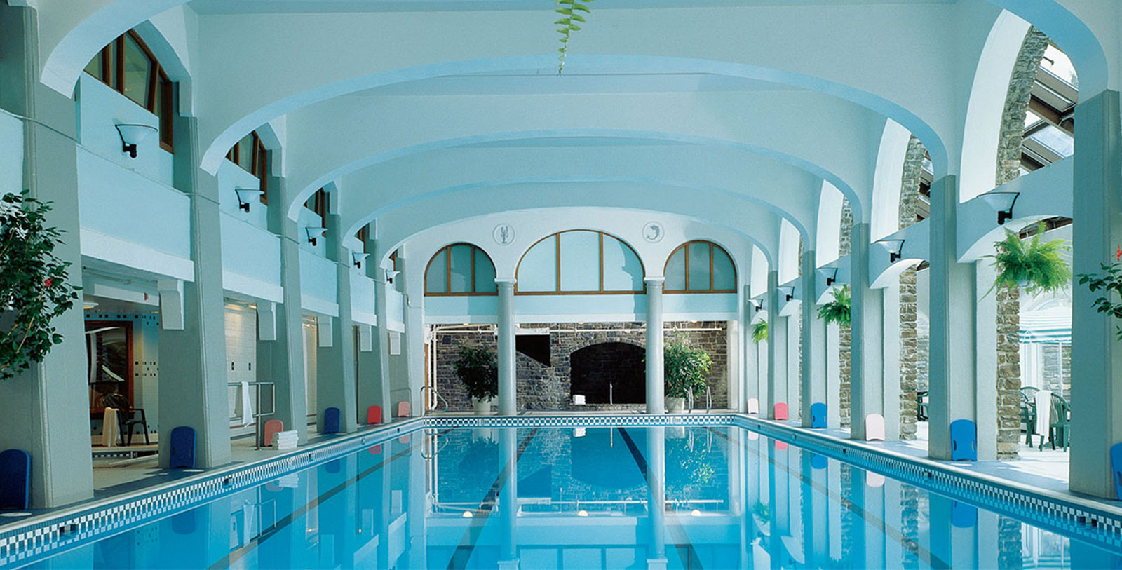 a indoor swimming pool with arched ceiling