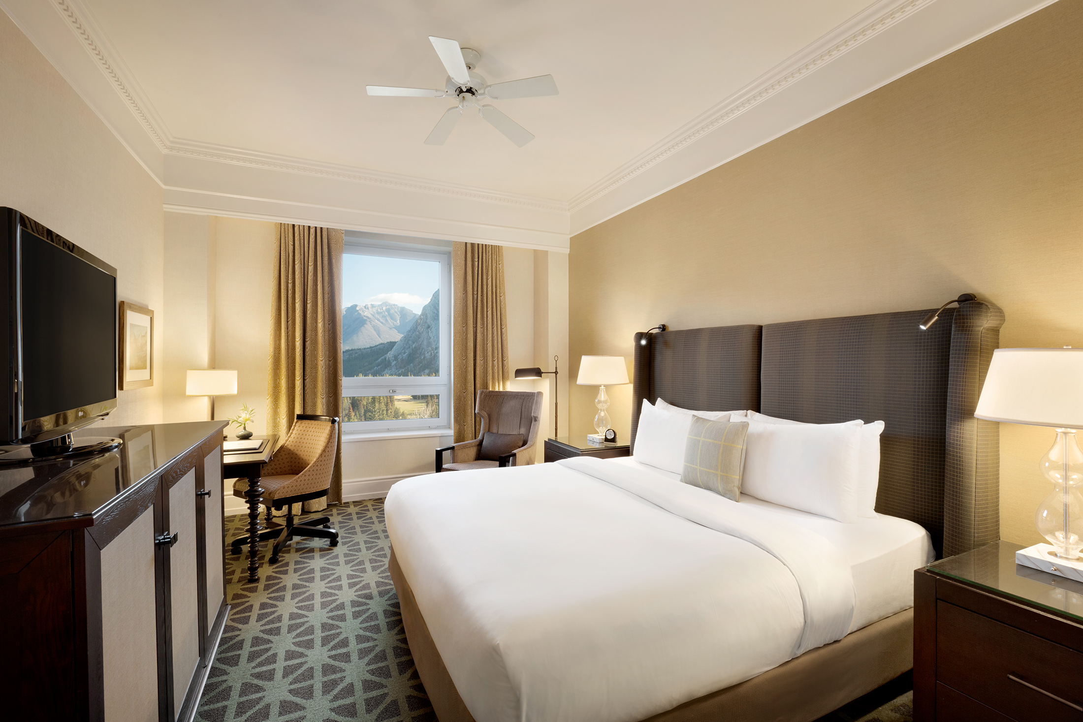 a room with a bed and a fan