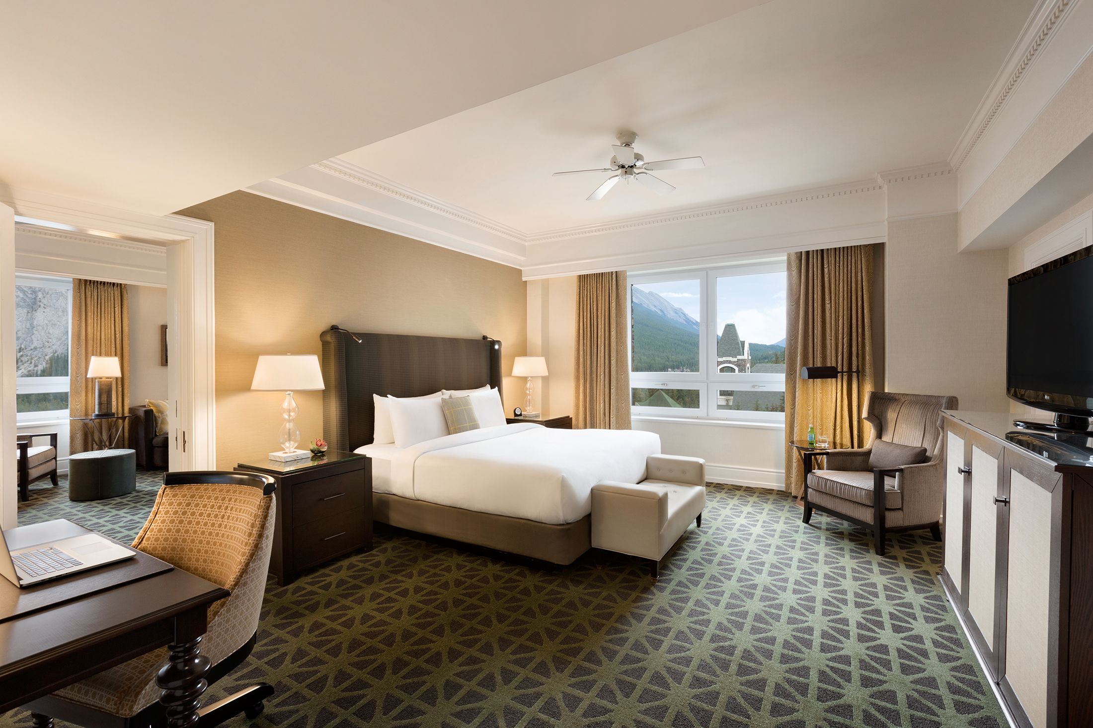 a room with a bed and chairs and a table
