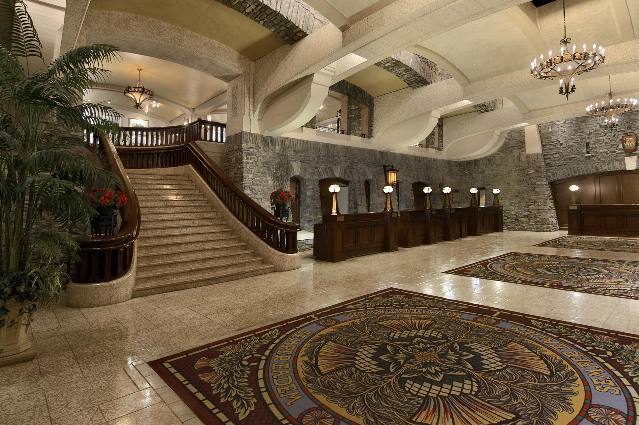 a large hall with a staircase and a rug