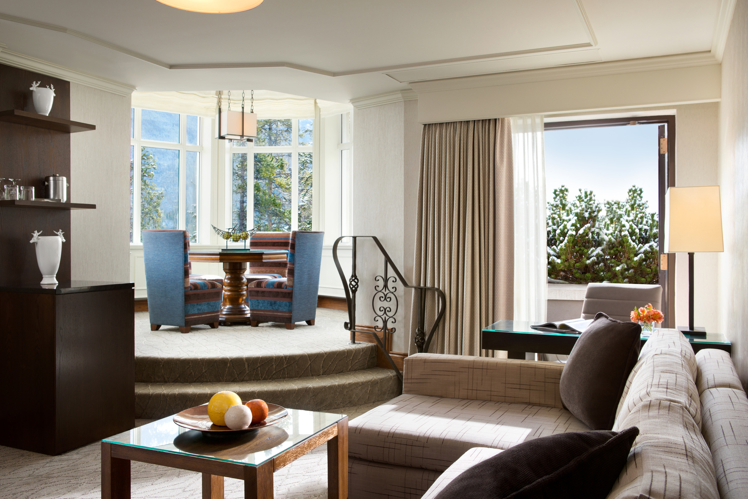 a living room with a round table and chairs