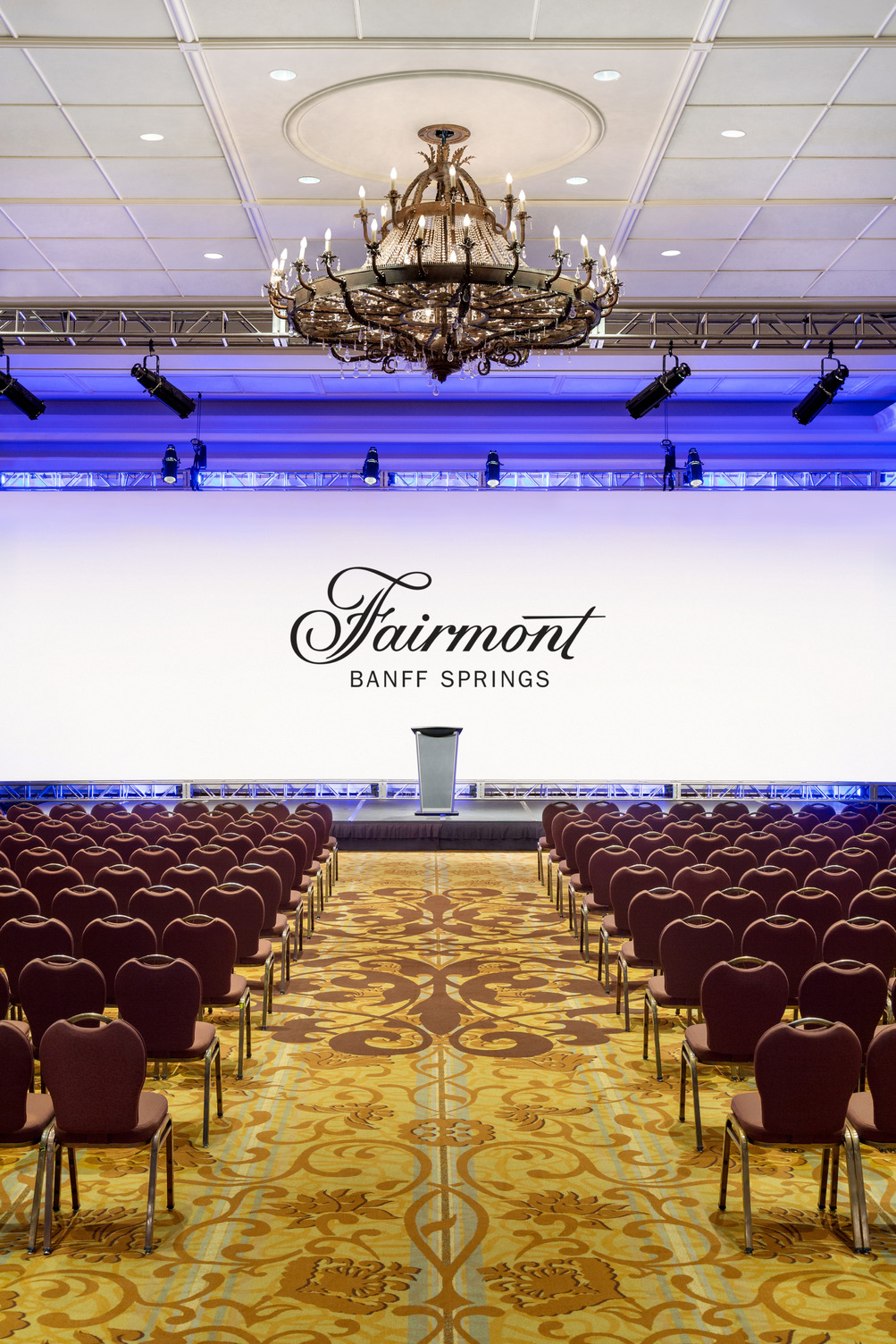 a large room with a stage and chairs