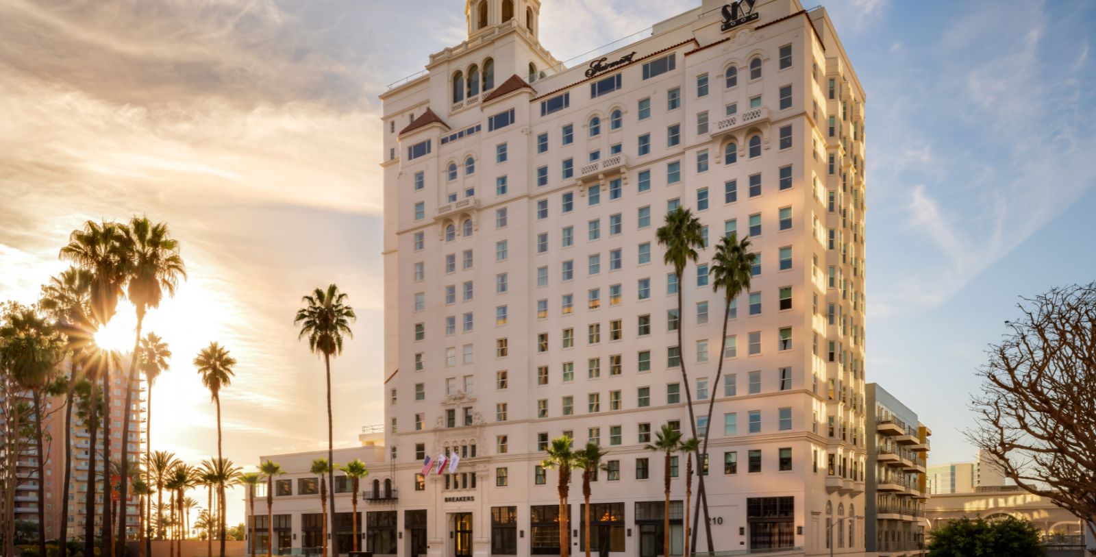 a large white building with palm trees