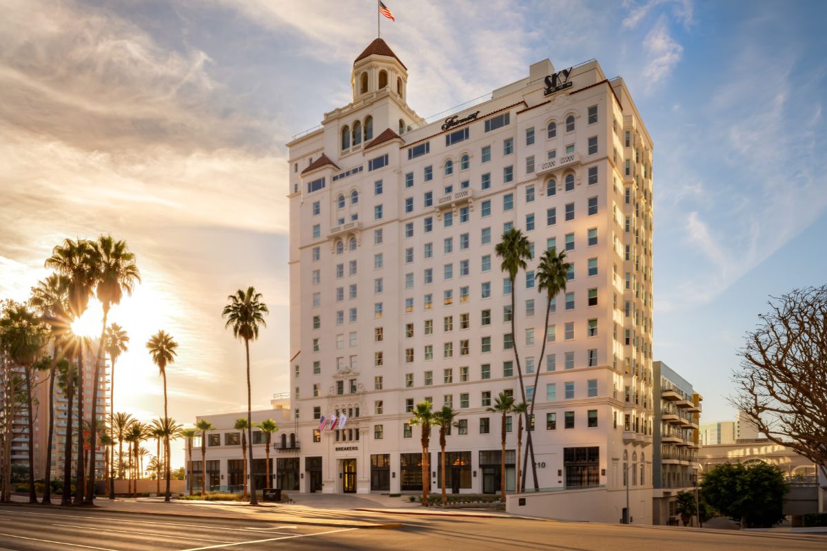 a building with palm trees and a street