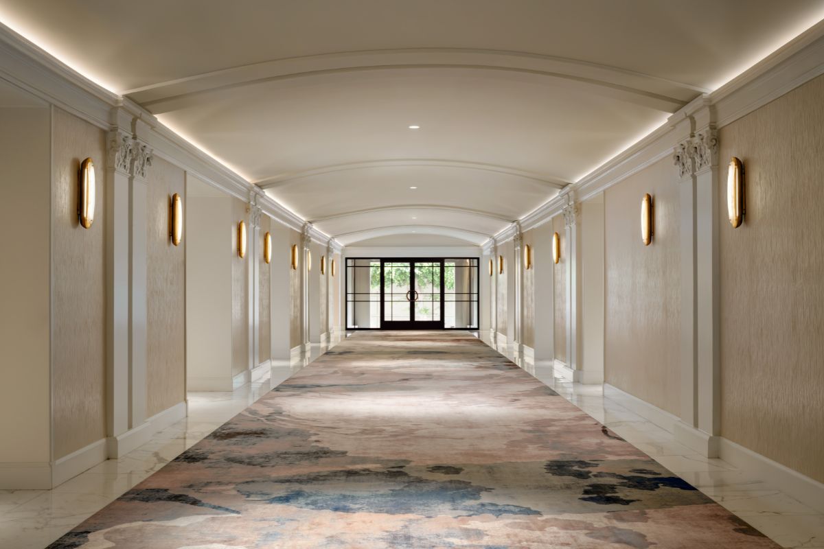 a hallway with a door and a glass door