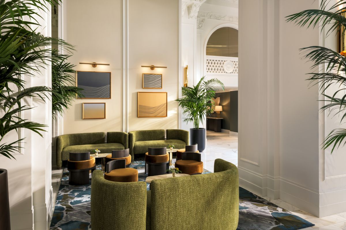 a room with green couches and tables