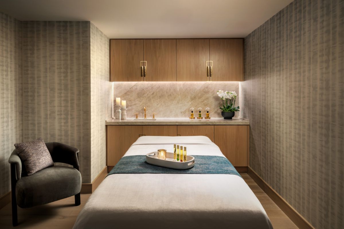 a massage room with a bed and candles