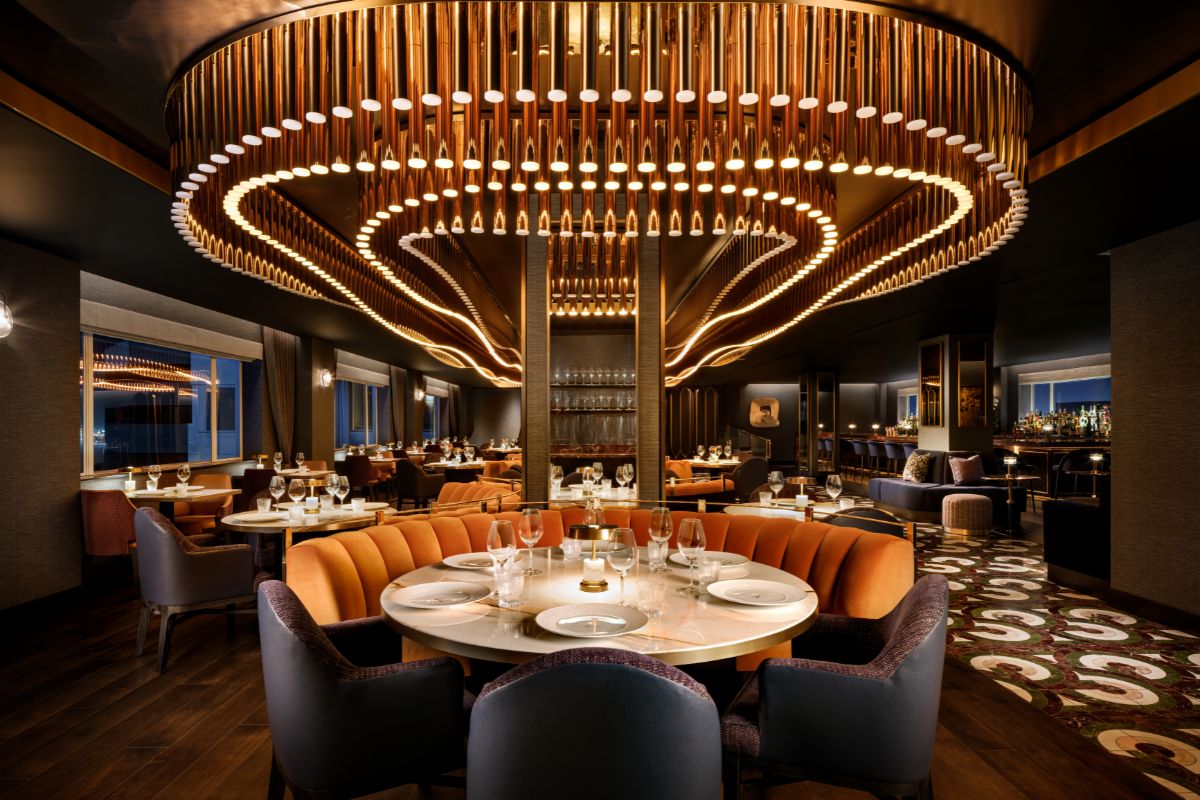 a restaurant with a chandelier and tables