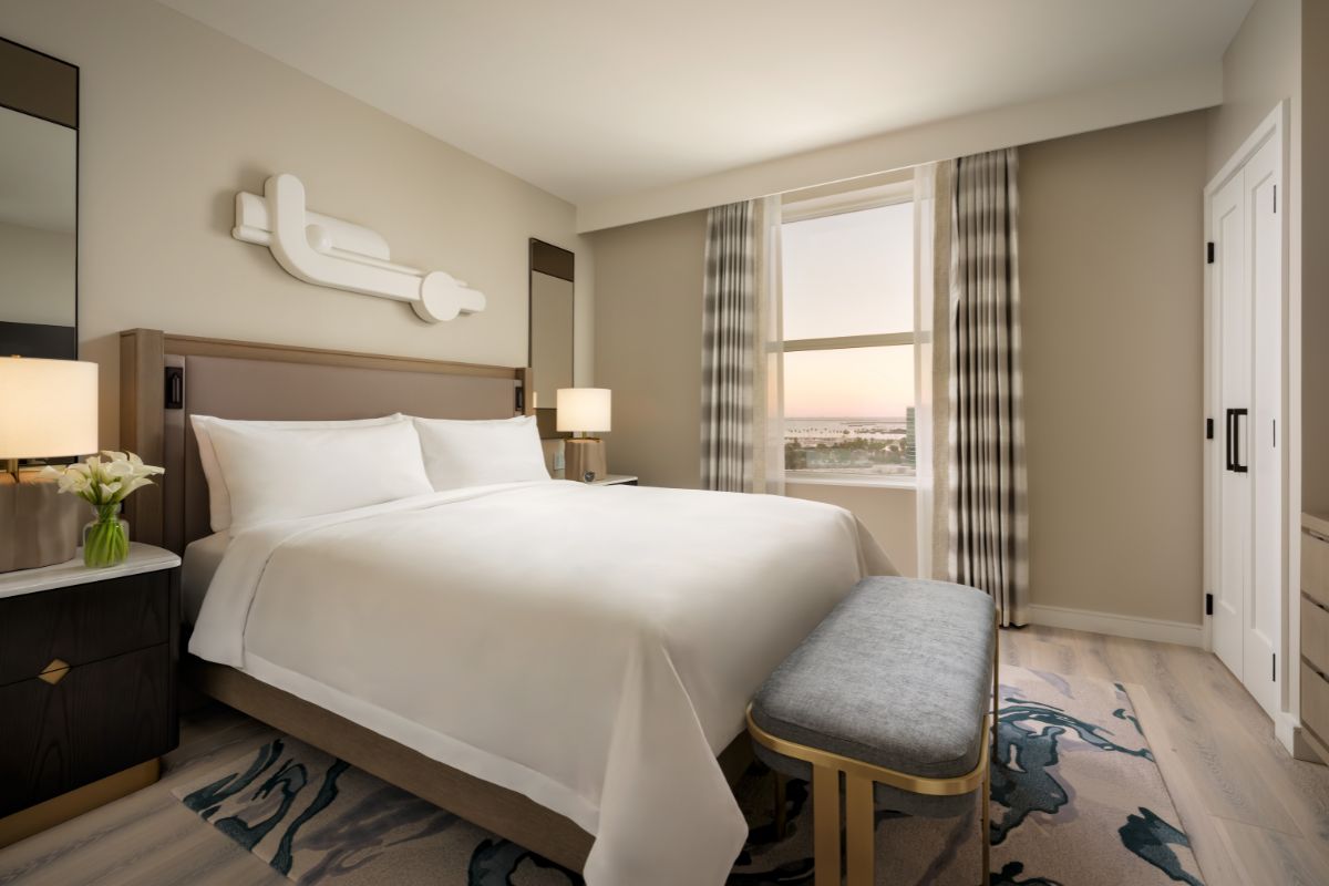 a bed with a bench in a hotel room