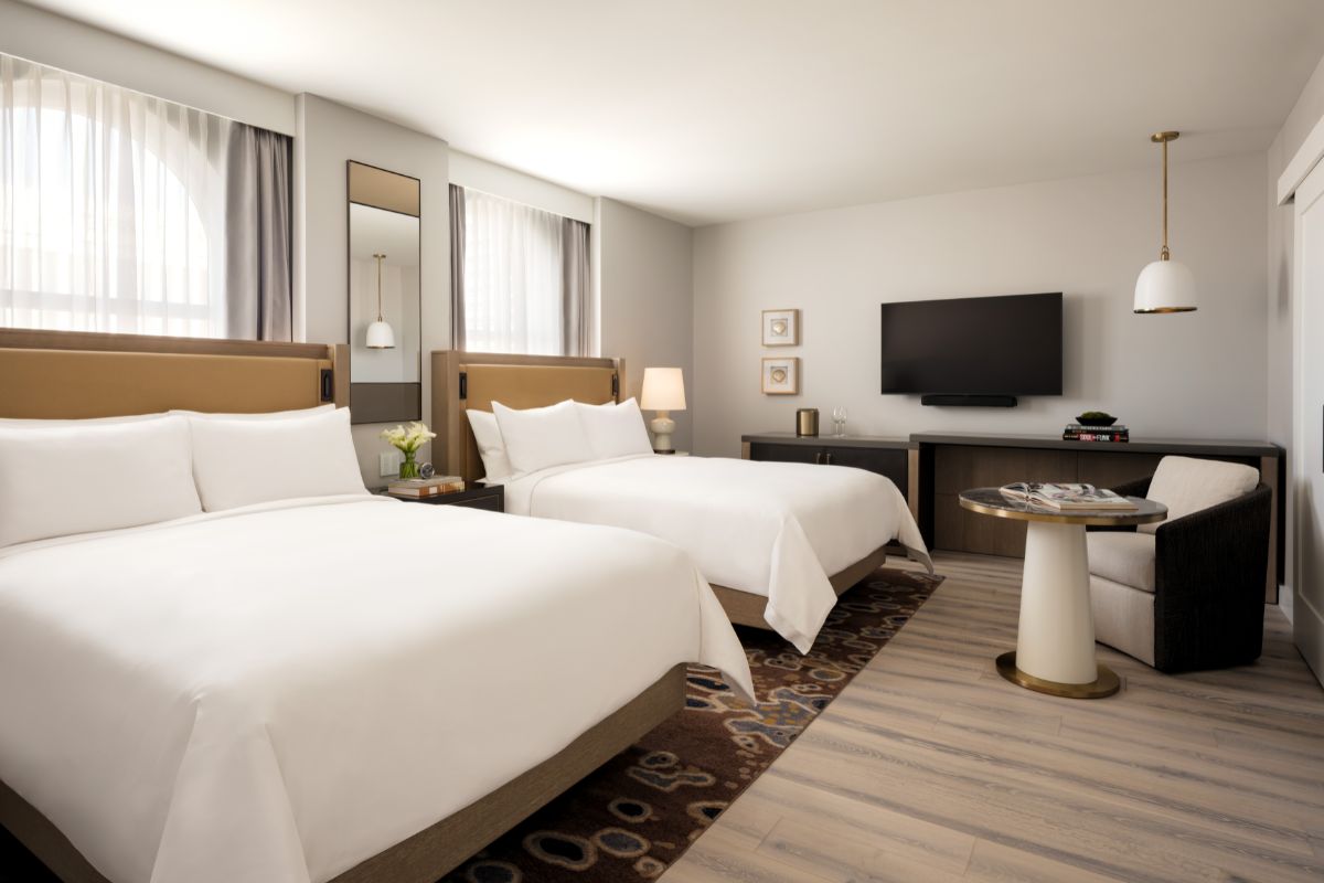 a room with two beds and a television