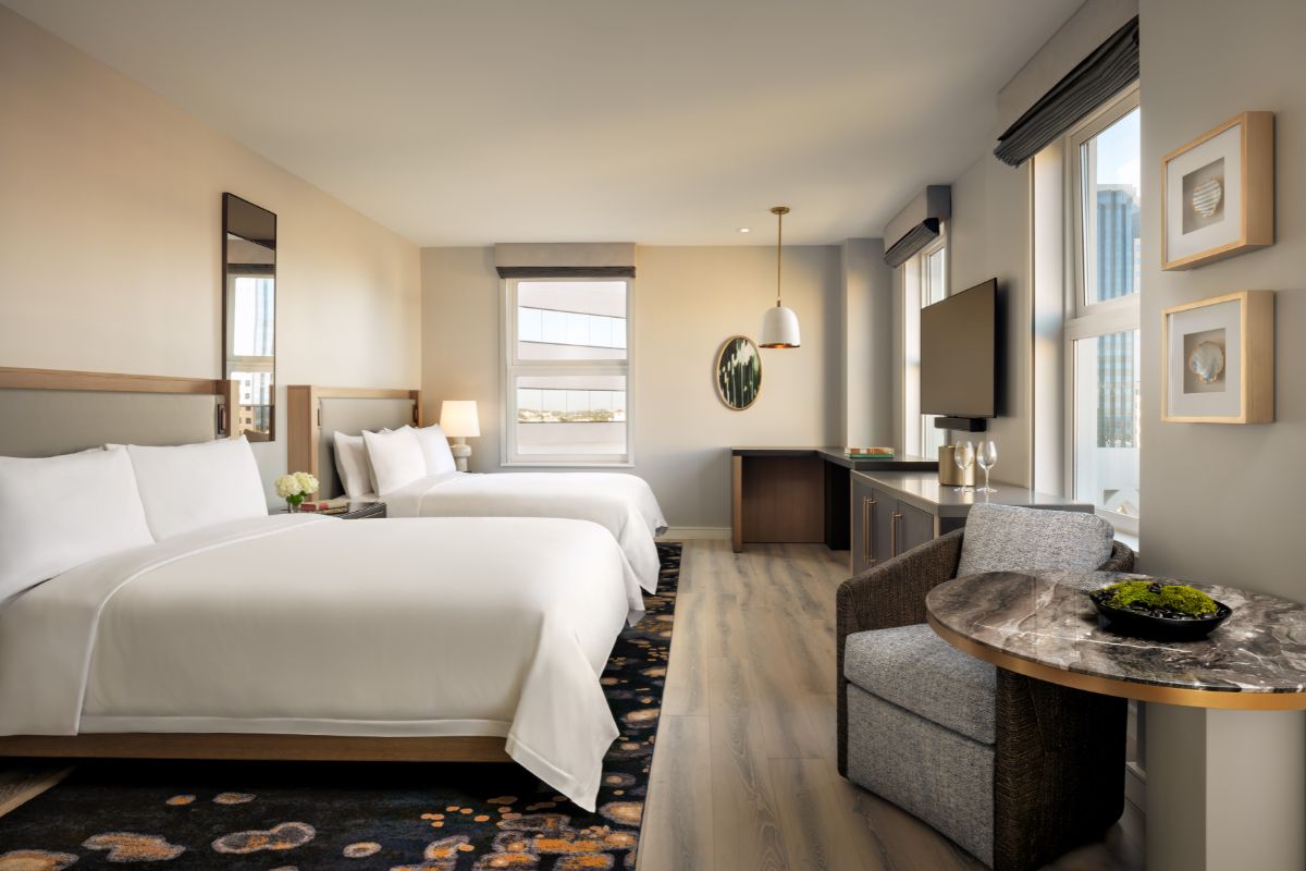 a room with two beds and a table