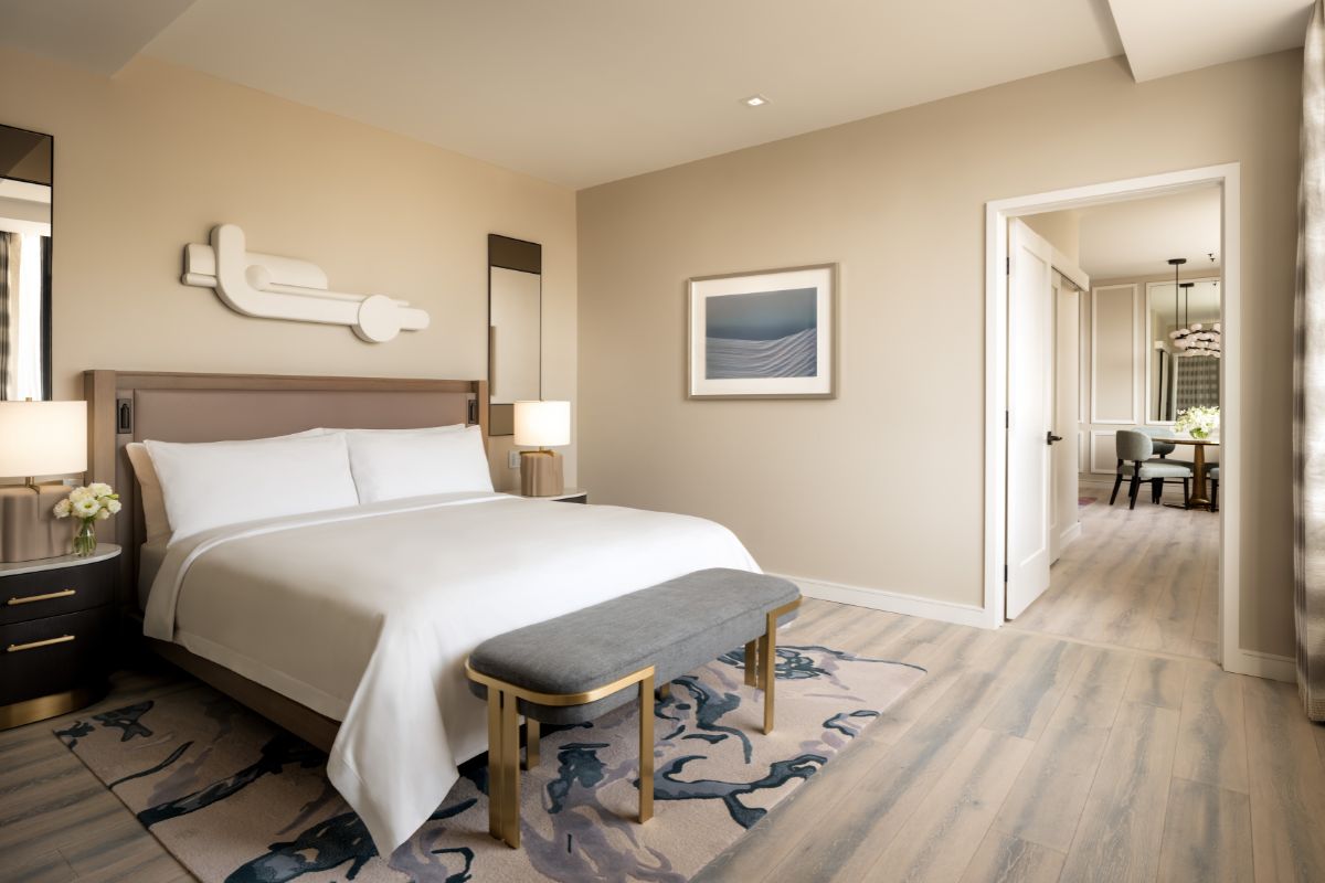 a bedroom with a bed and a bench