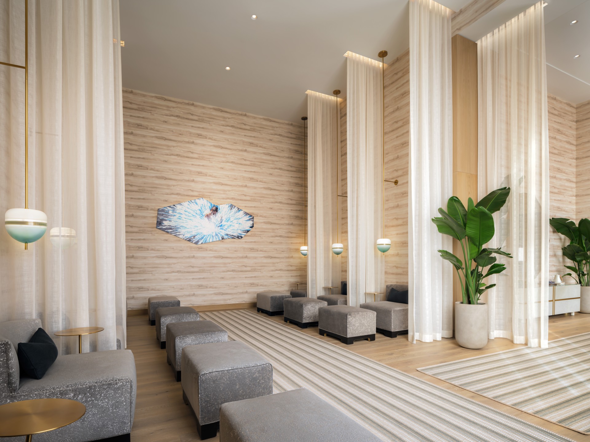 a room with a large group of grey stools and a plant