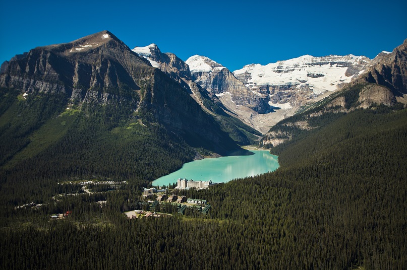 a lake surrounded by trees and mountains