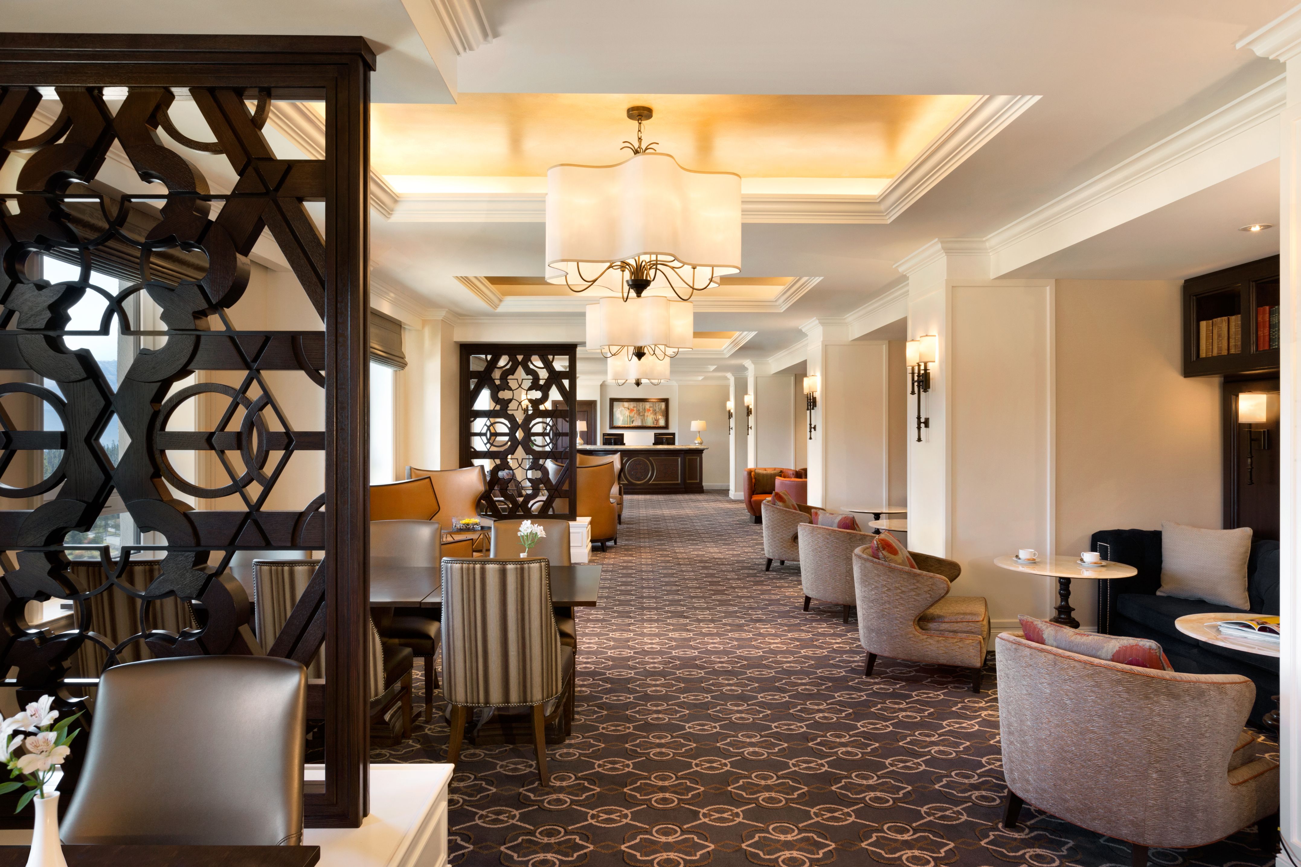 a room with a large chandelier and chairs