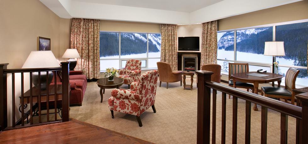 a room with a fireplace and chairs