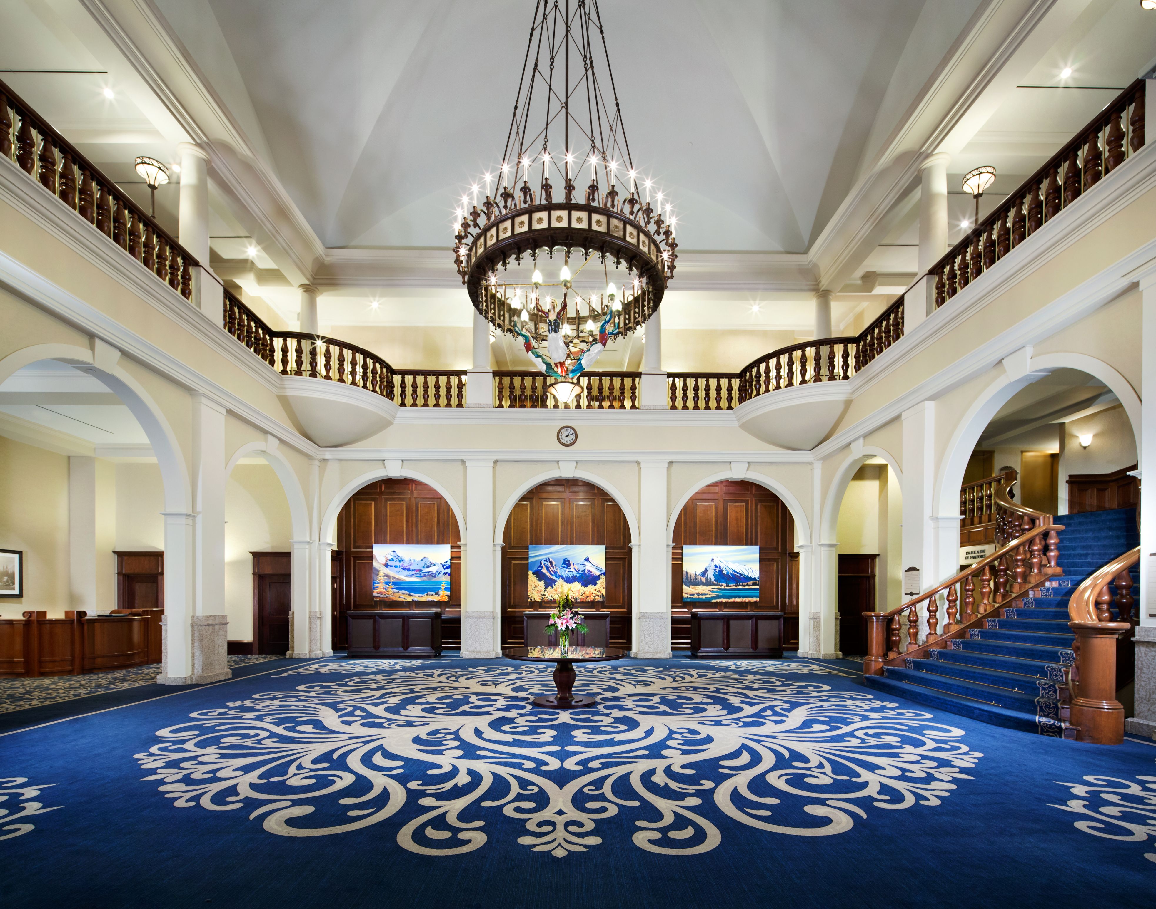 a large room with blue carpet and chandelier