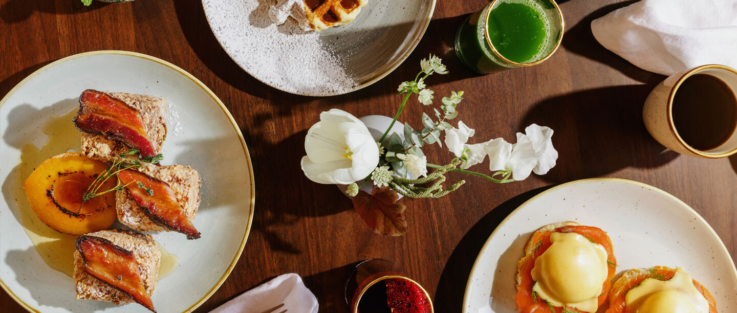 a table with plates of food and drinks