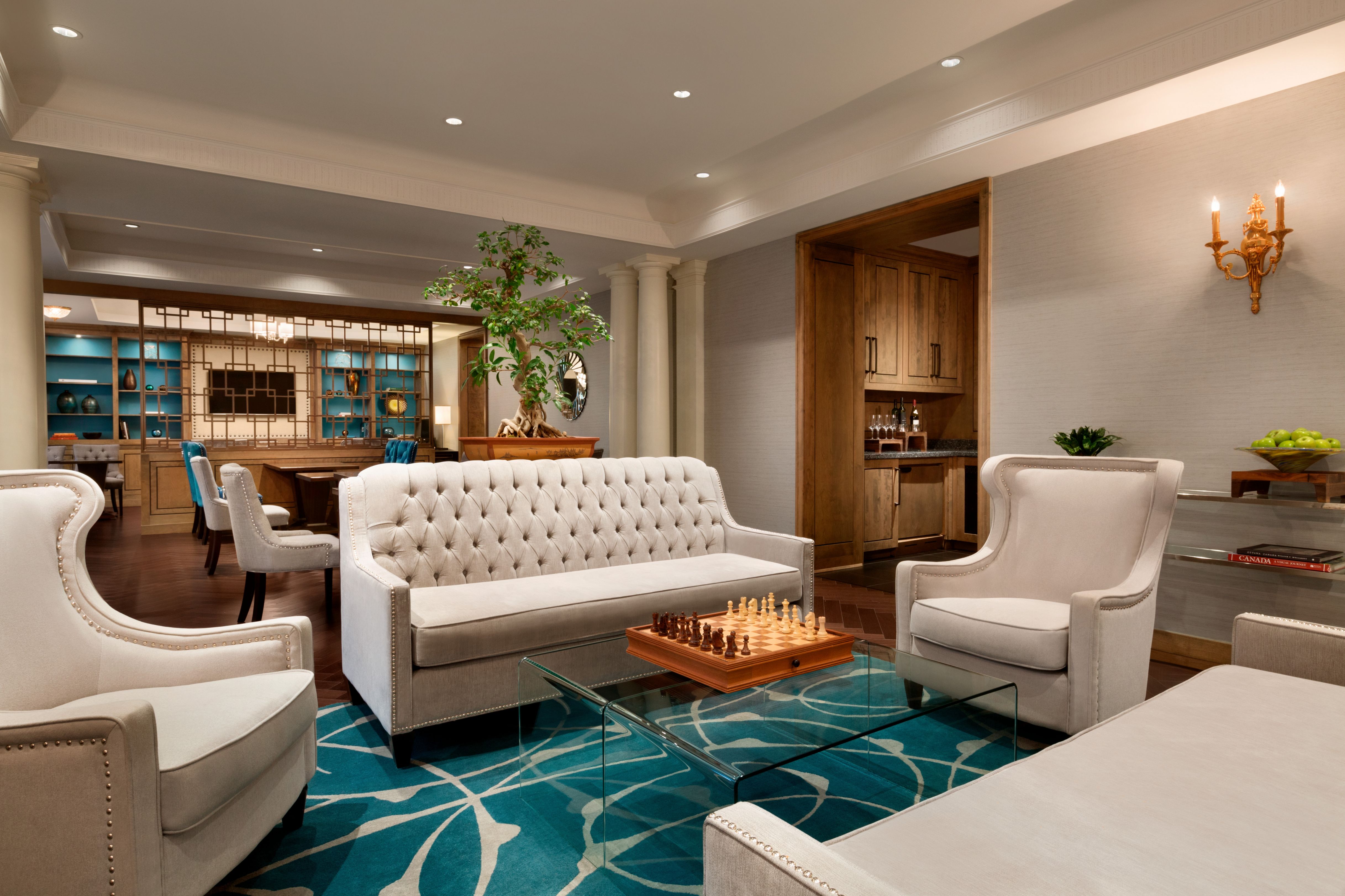 a room with white couches and a chess board