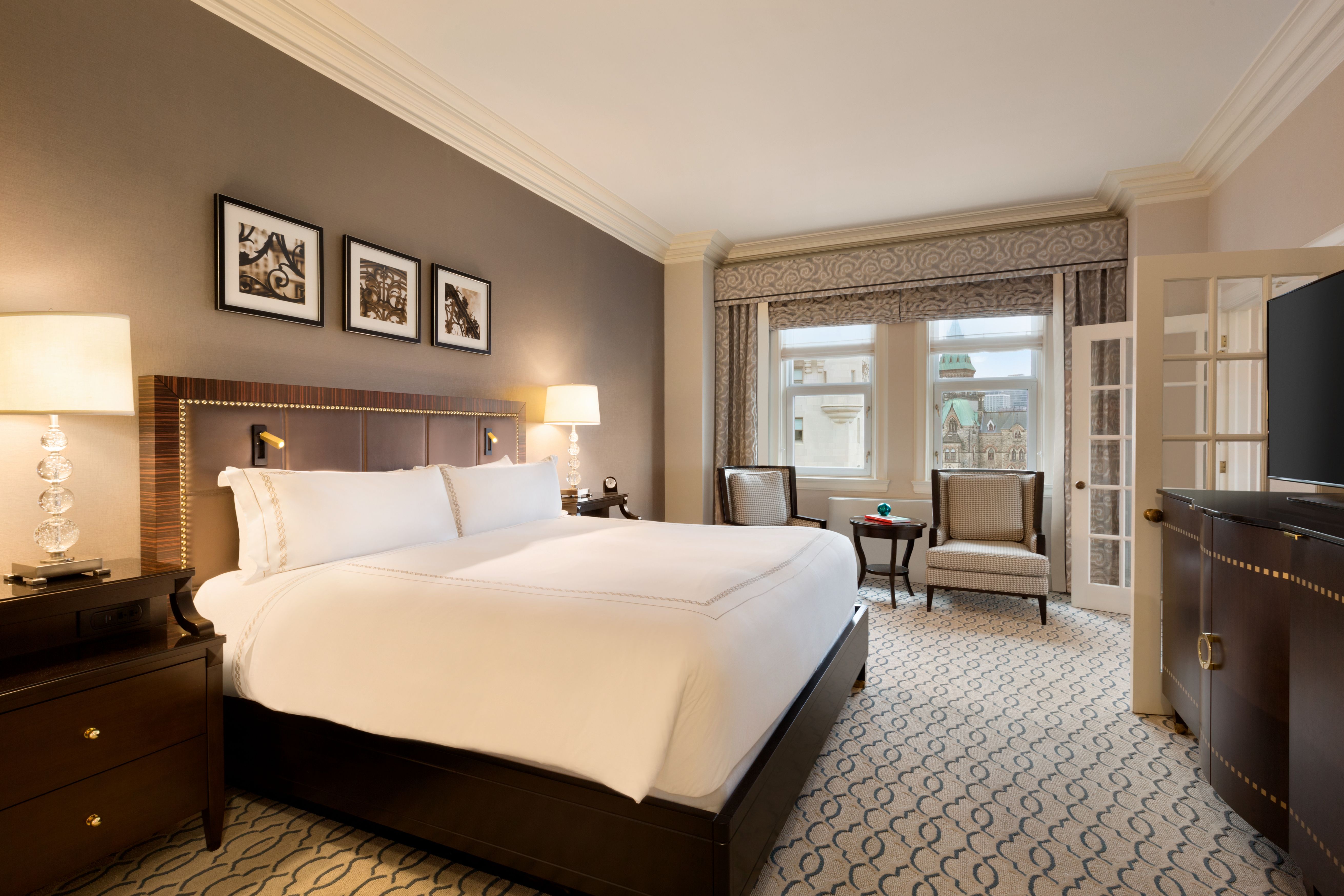 a bedroom with a bed and chairs