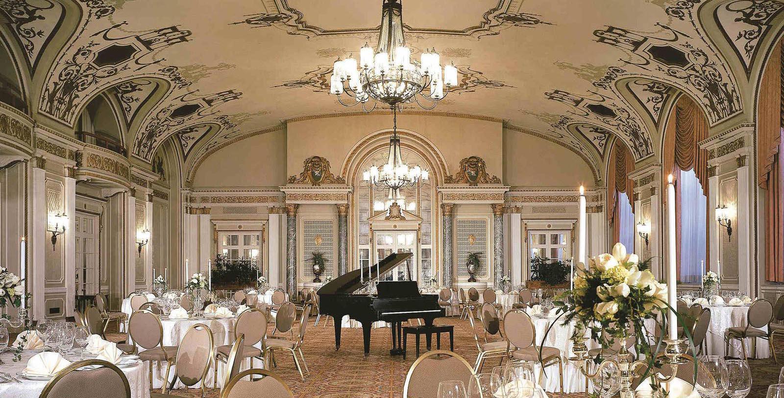 a room with a piano and tables