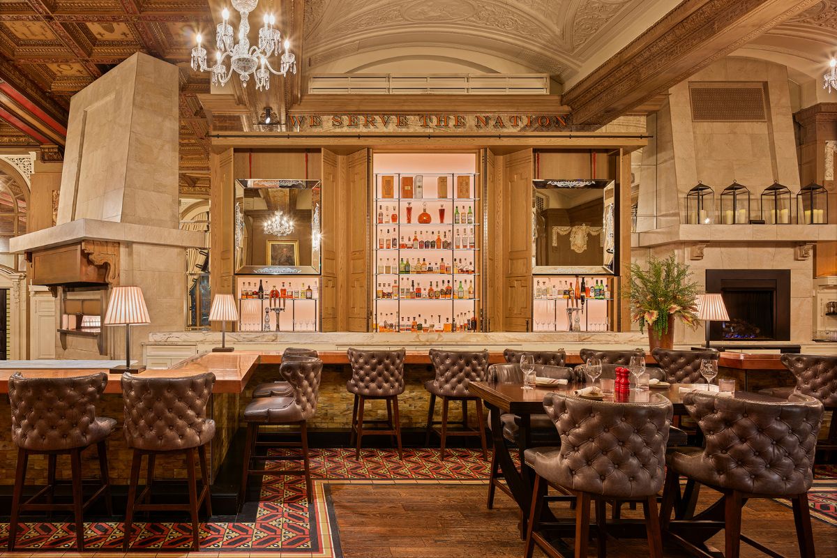 a restaurant with a bar and chairs