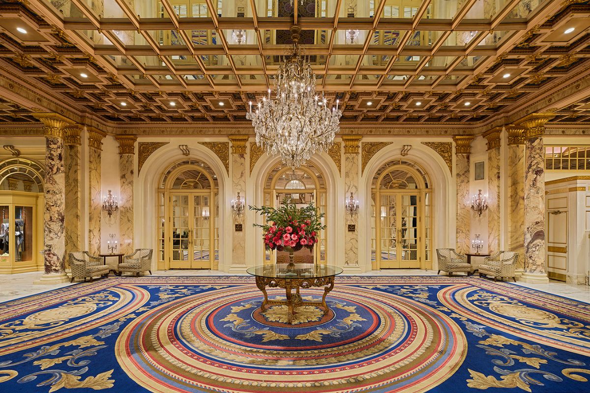 a large room with a chandelier and flowers