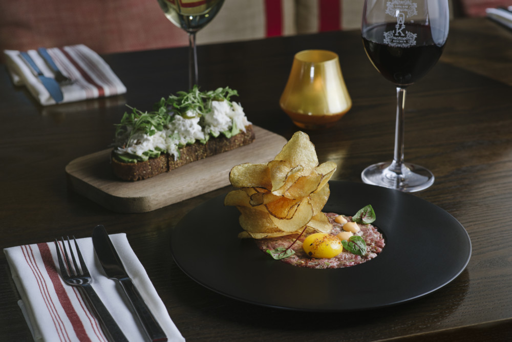 a plate of food and a glass of wine