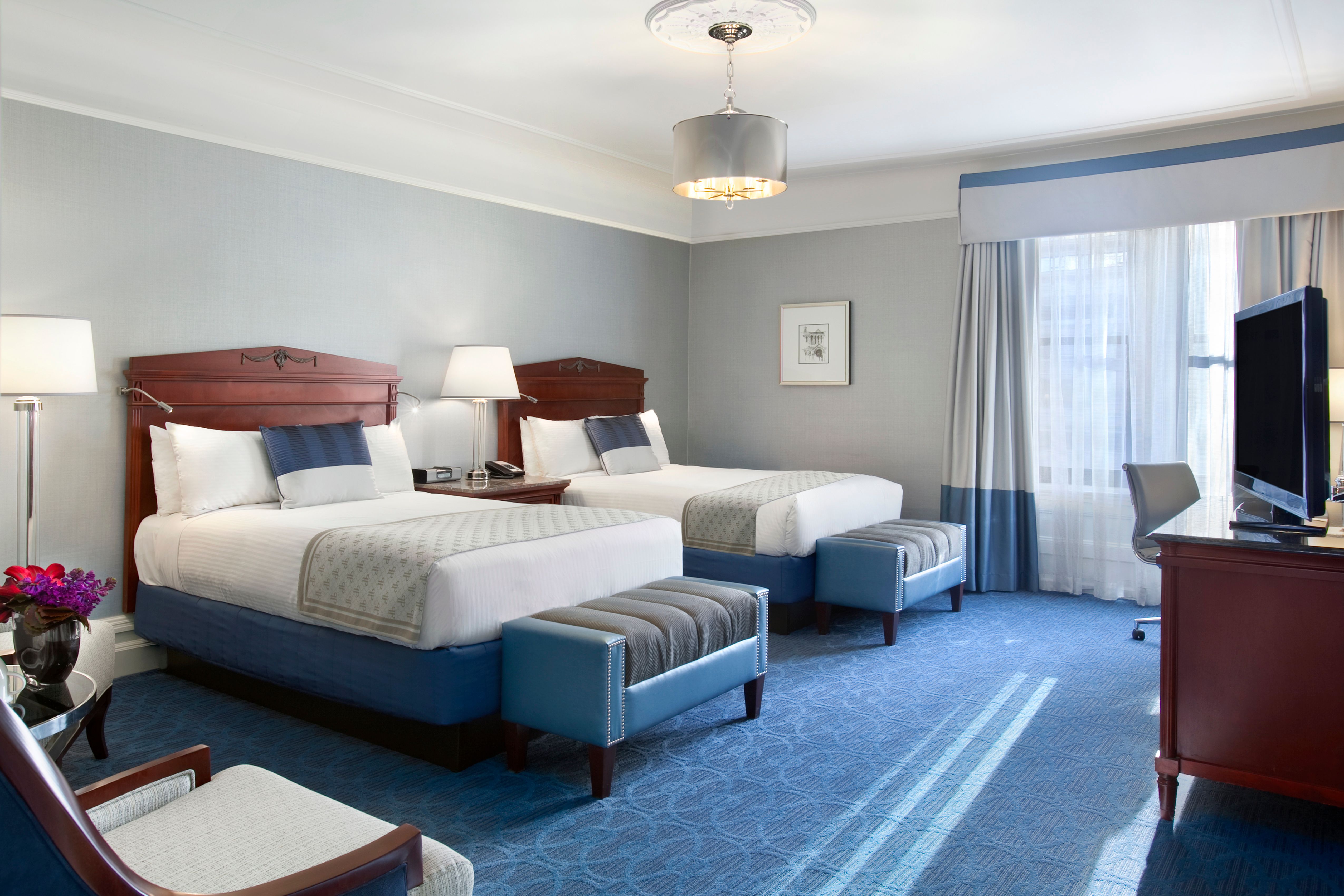 a room with two beds and a lamp