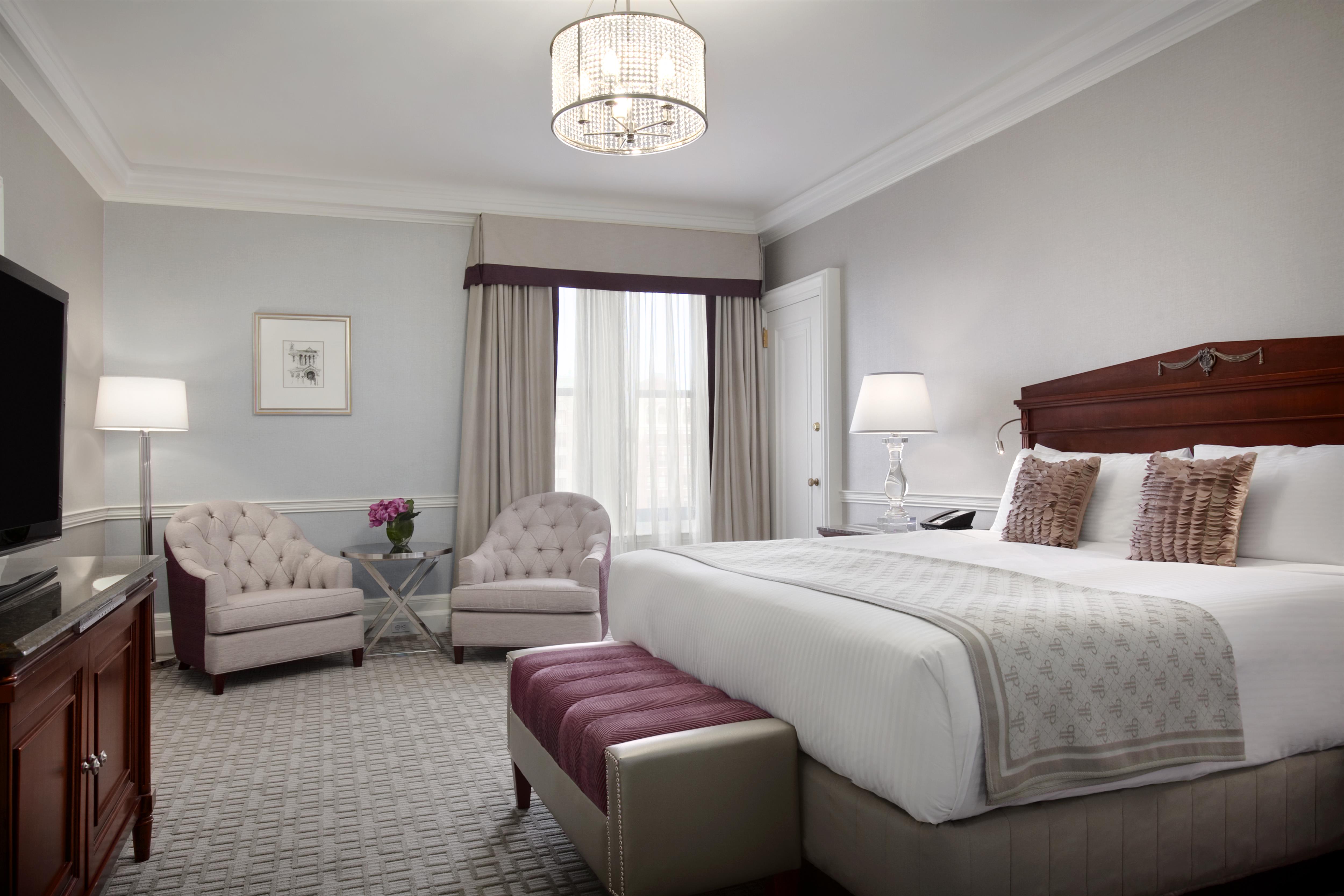 a bedroom with a bed and chairs