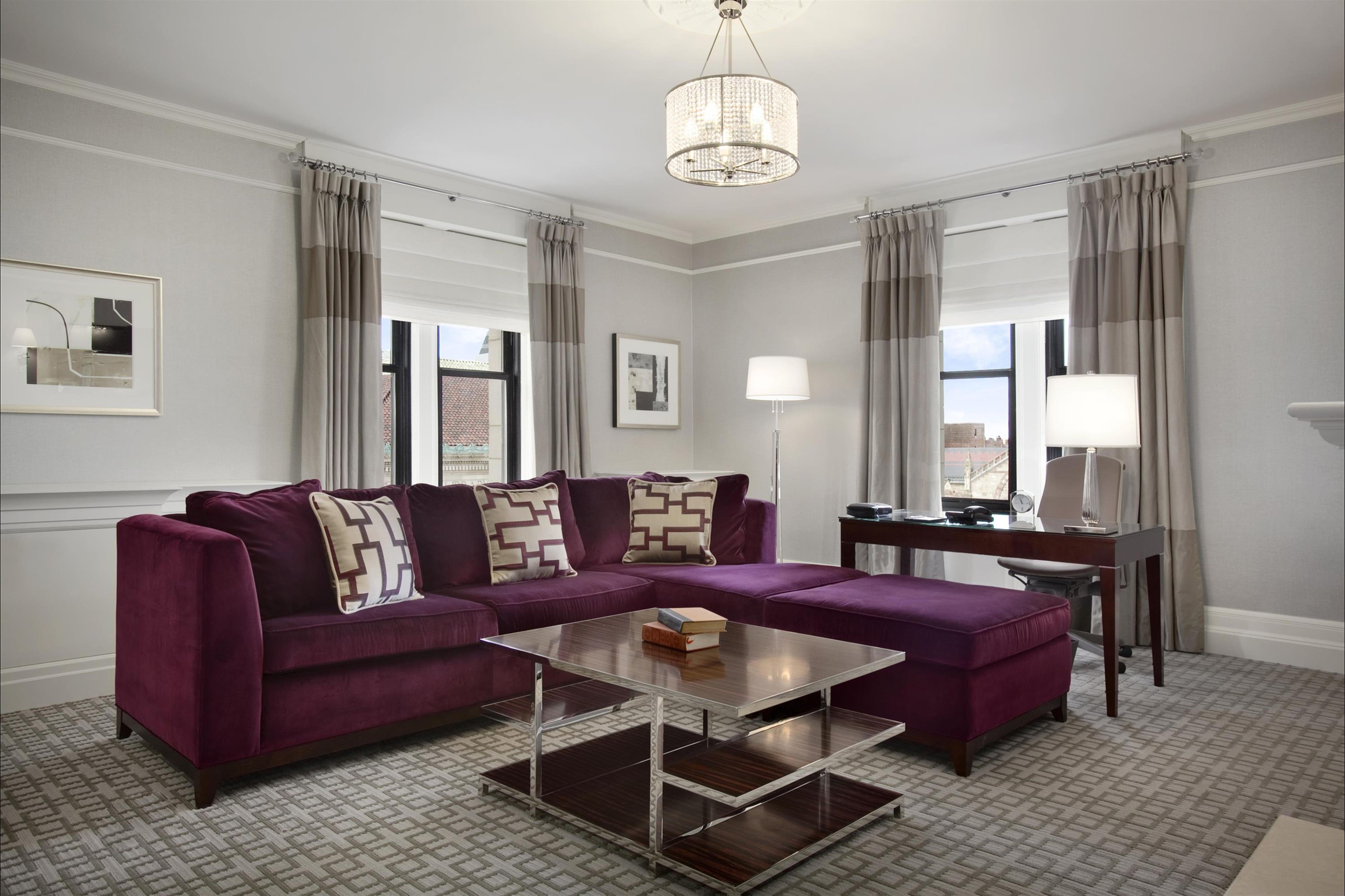 a living room with purple couches and a table