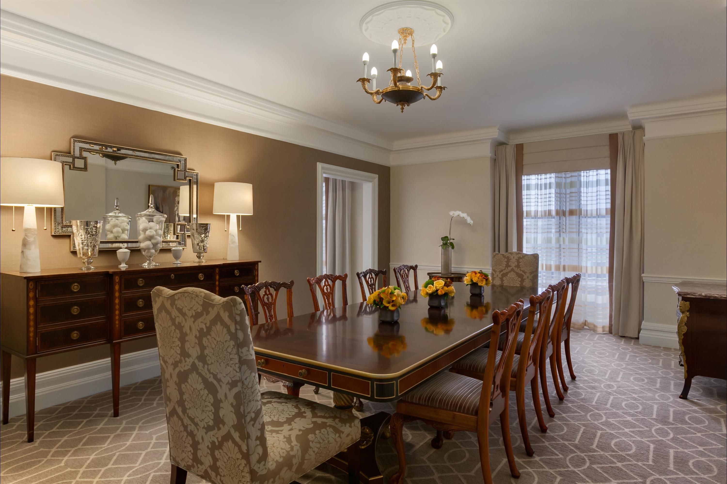 a dining room with a large table and chairs