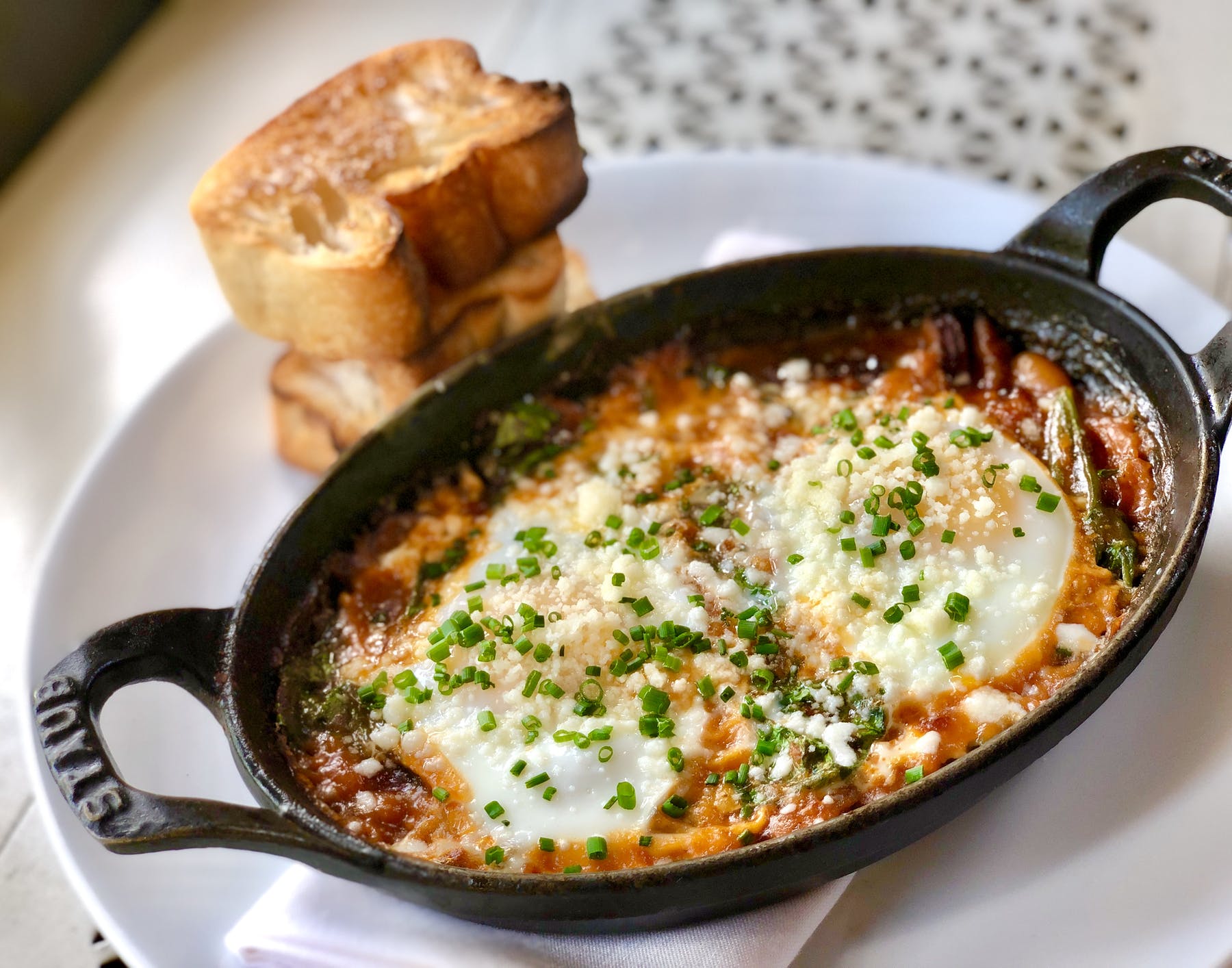 a pan of food with a slice of bread on a white plate