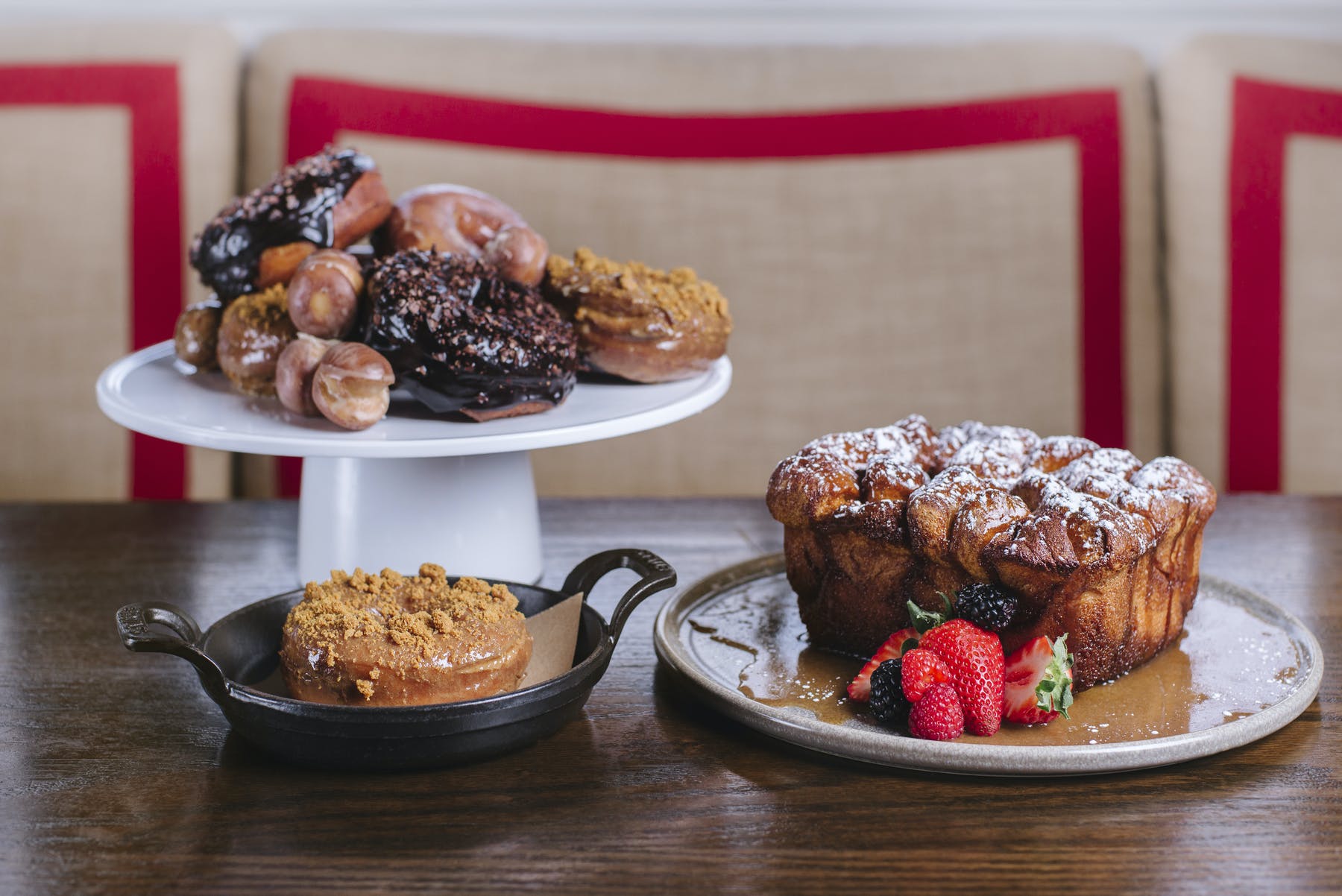 a plate of pastries and a plate of donuts on a table