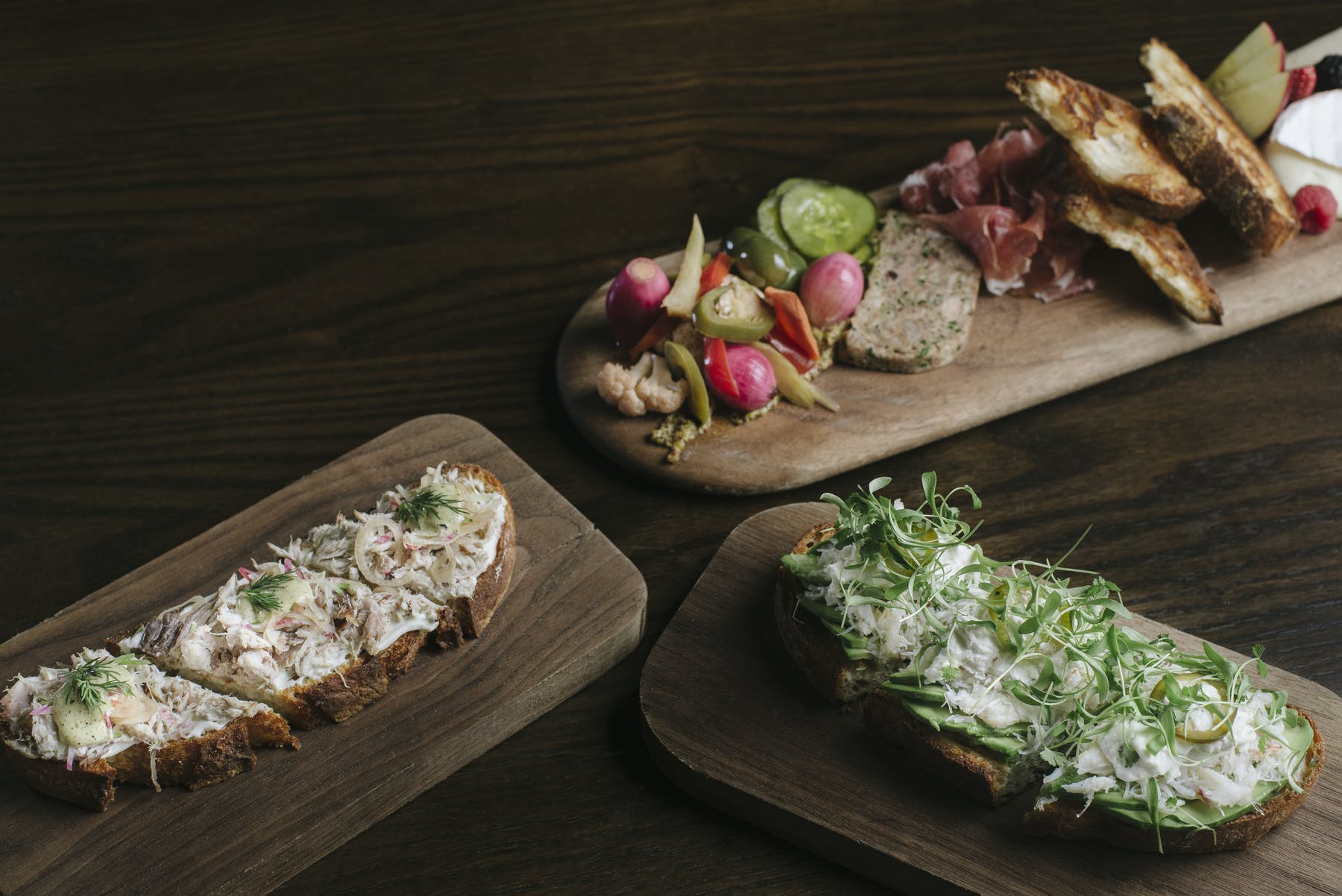 a group of sandwiches on wooden boards