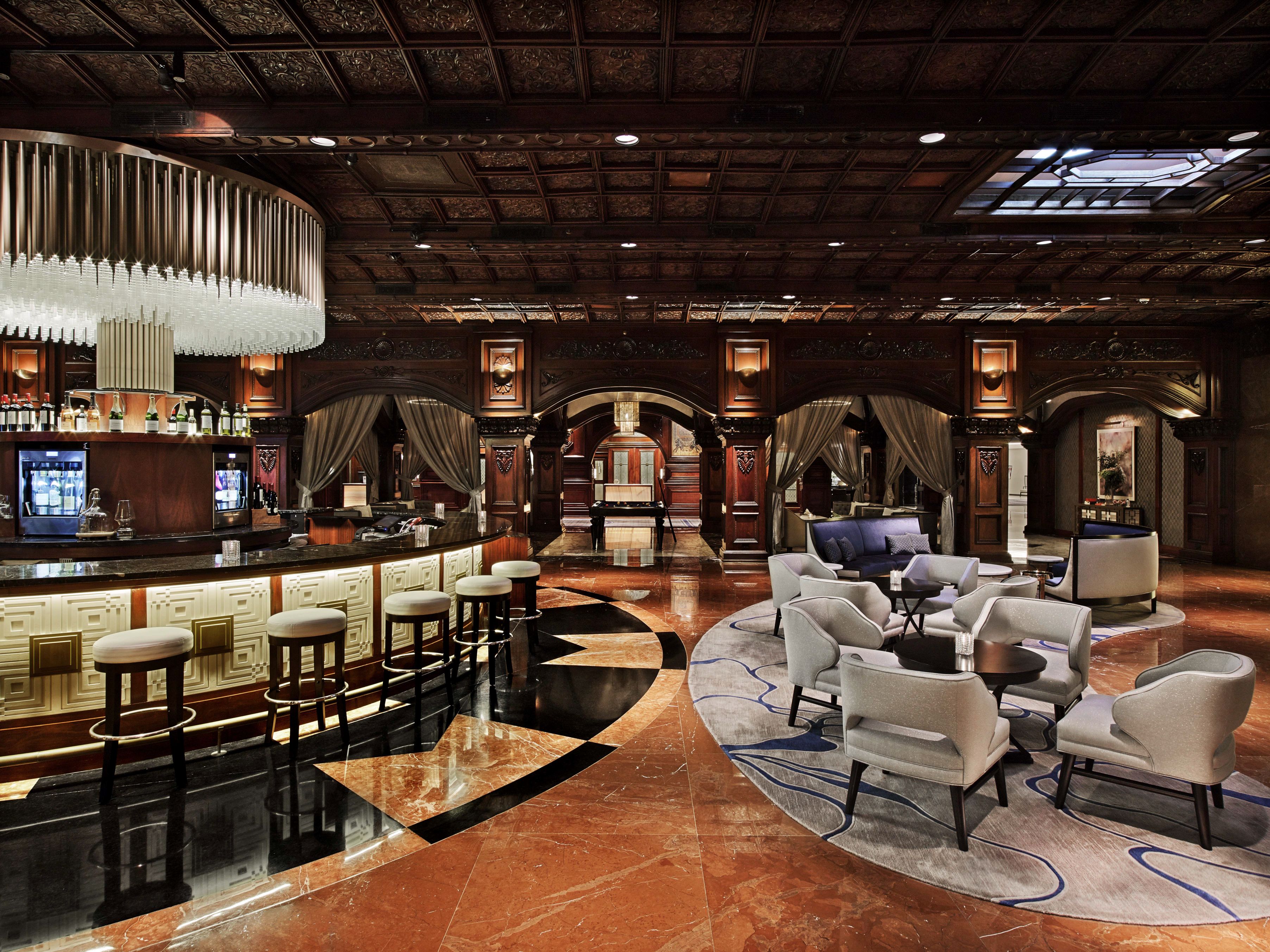a room with a bar and chairs