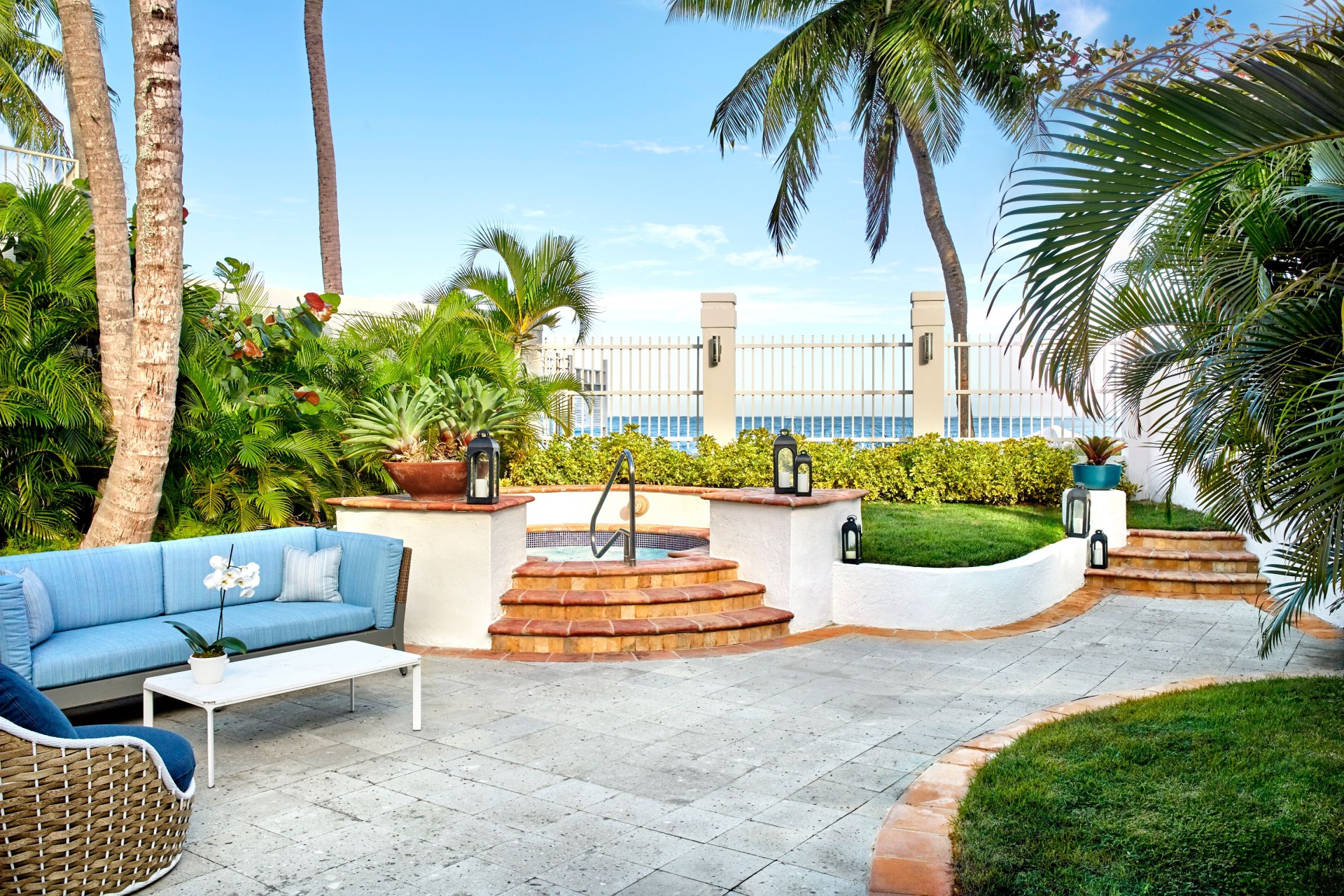 a patio with a hot tub and a pool