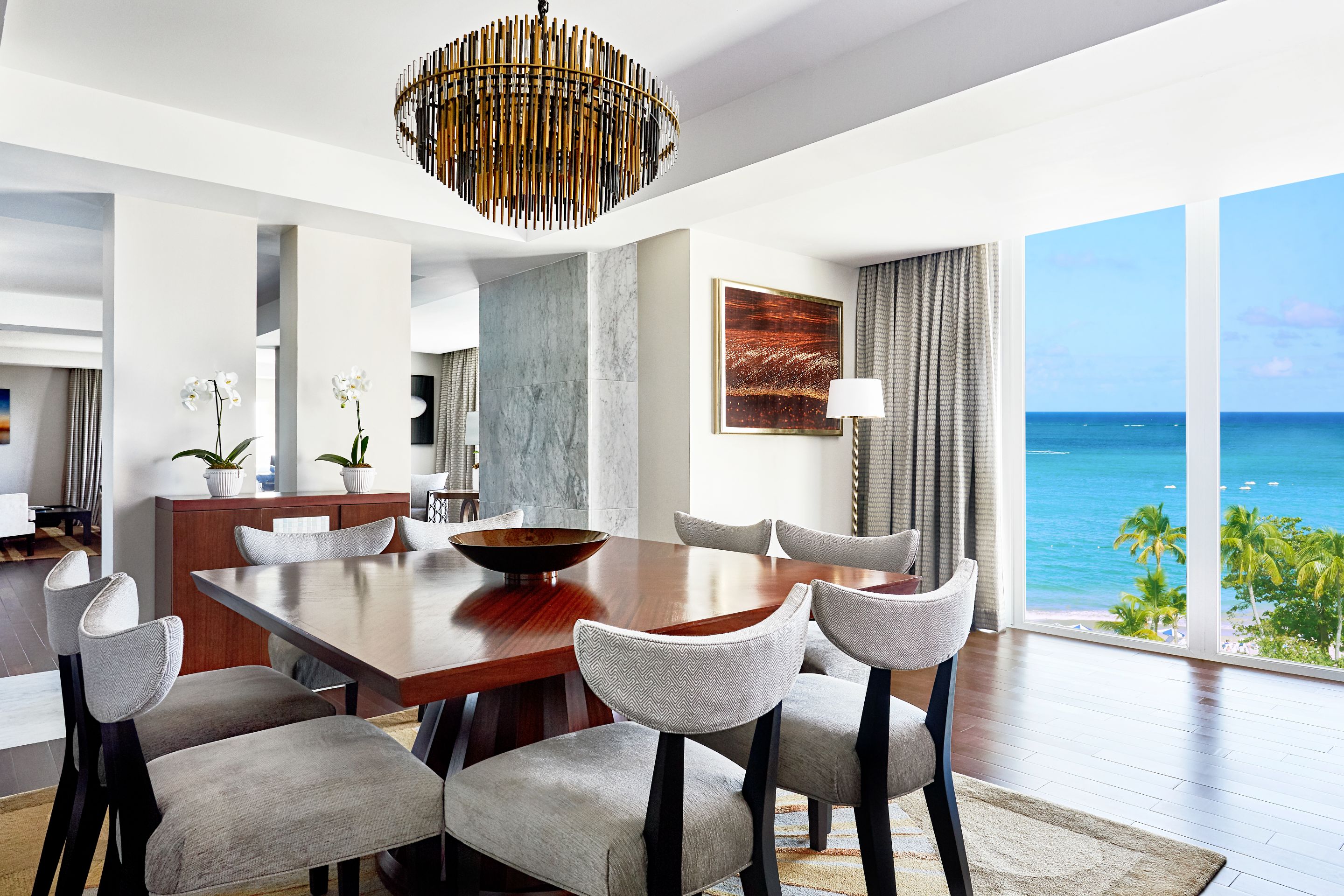 a room with a table and chairs and a chandelier