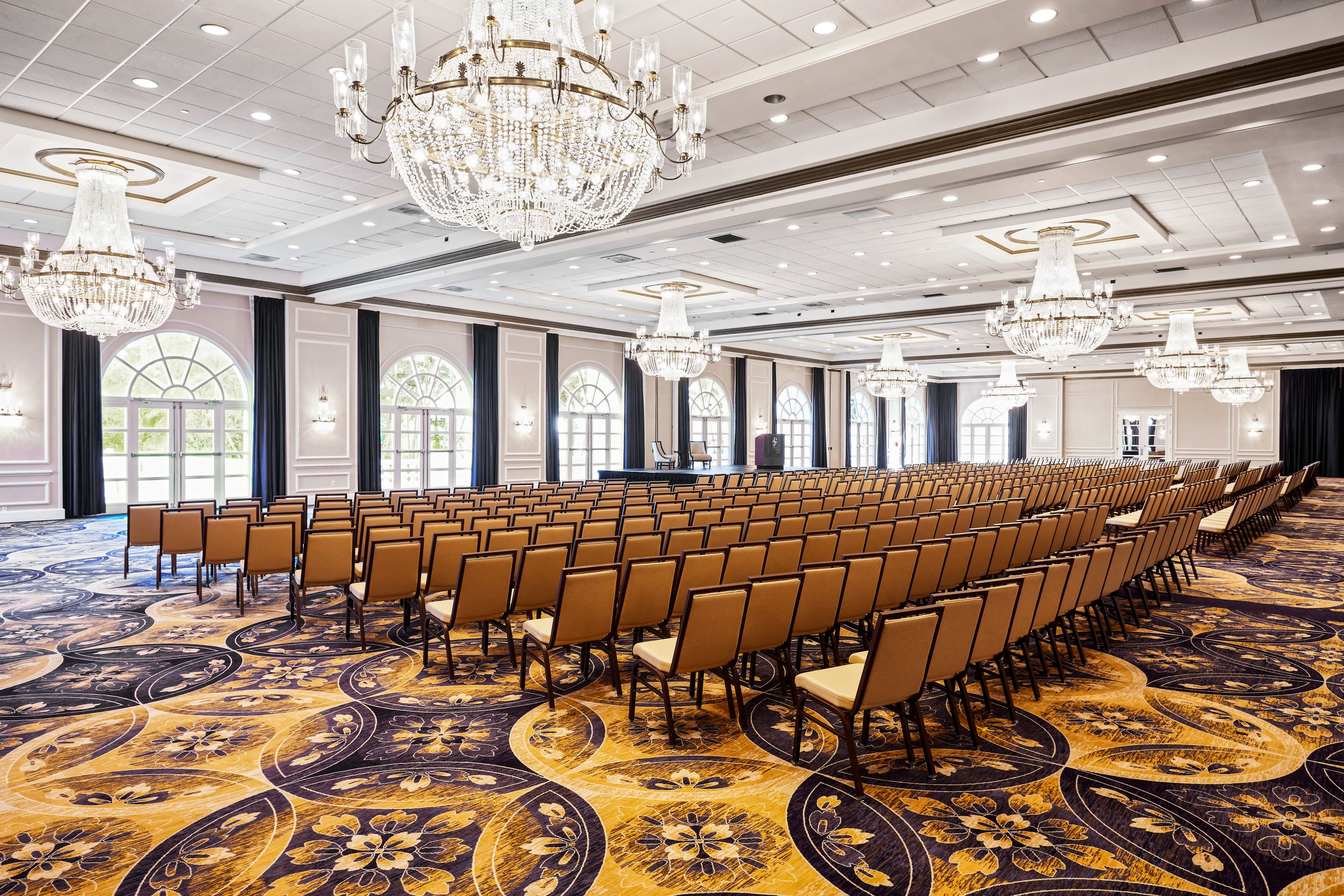 a room with chairs and chandeliers