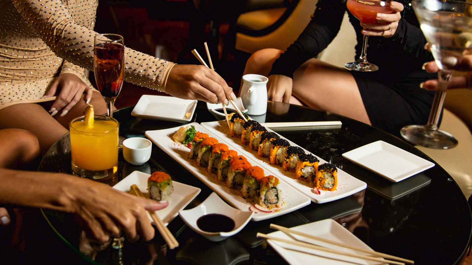 a group of people eating sushi