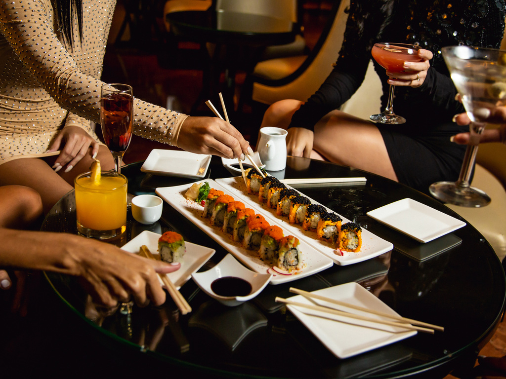 a group of people eating sushi