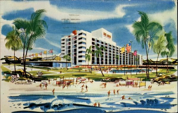 a hotel with a beach and palm trees