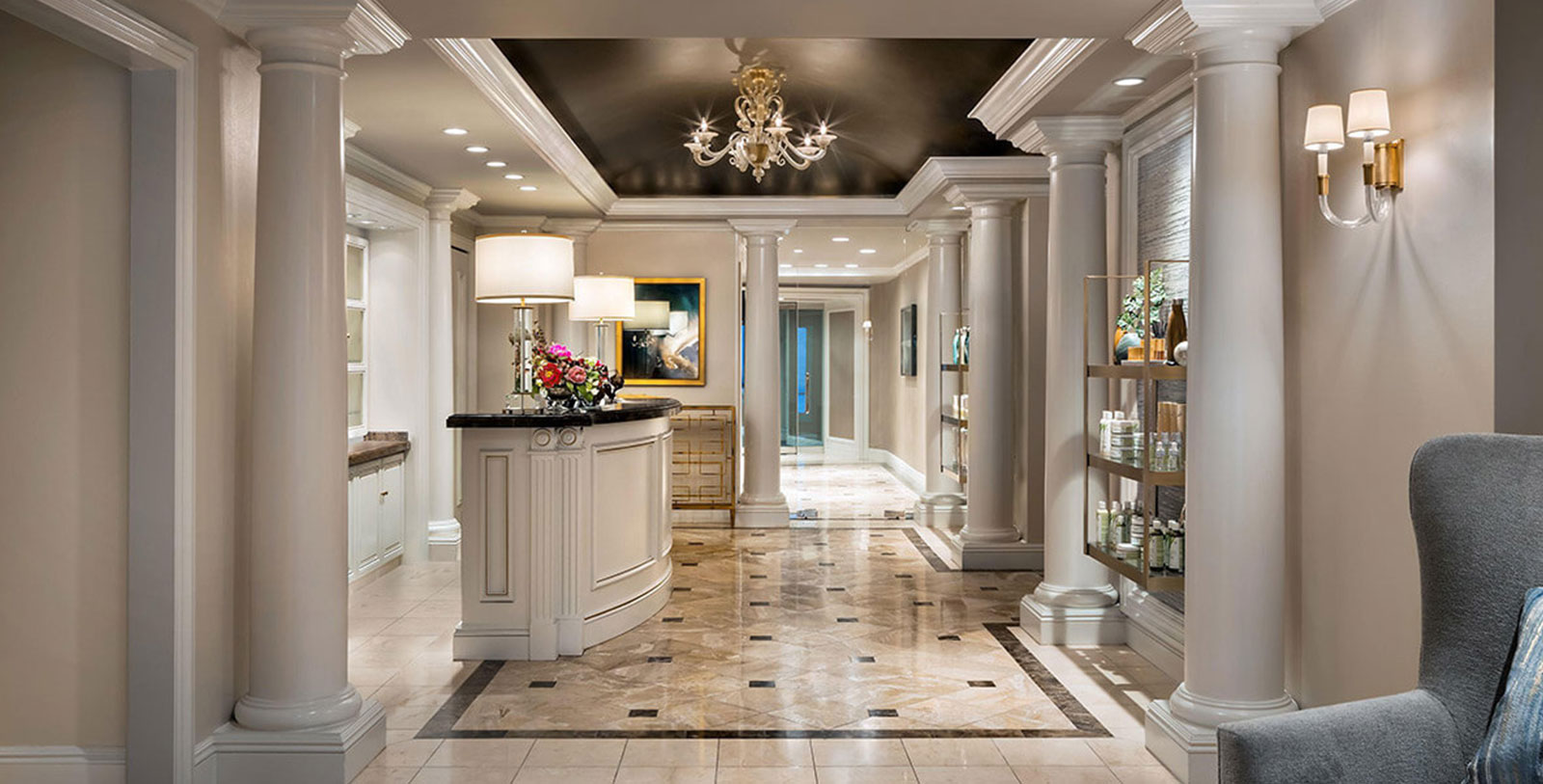 a room with a chandelier and shelves