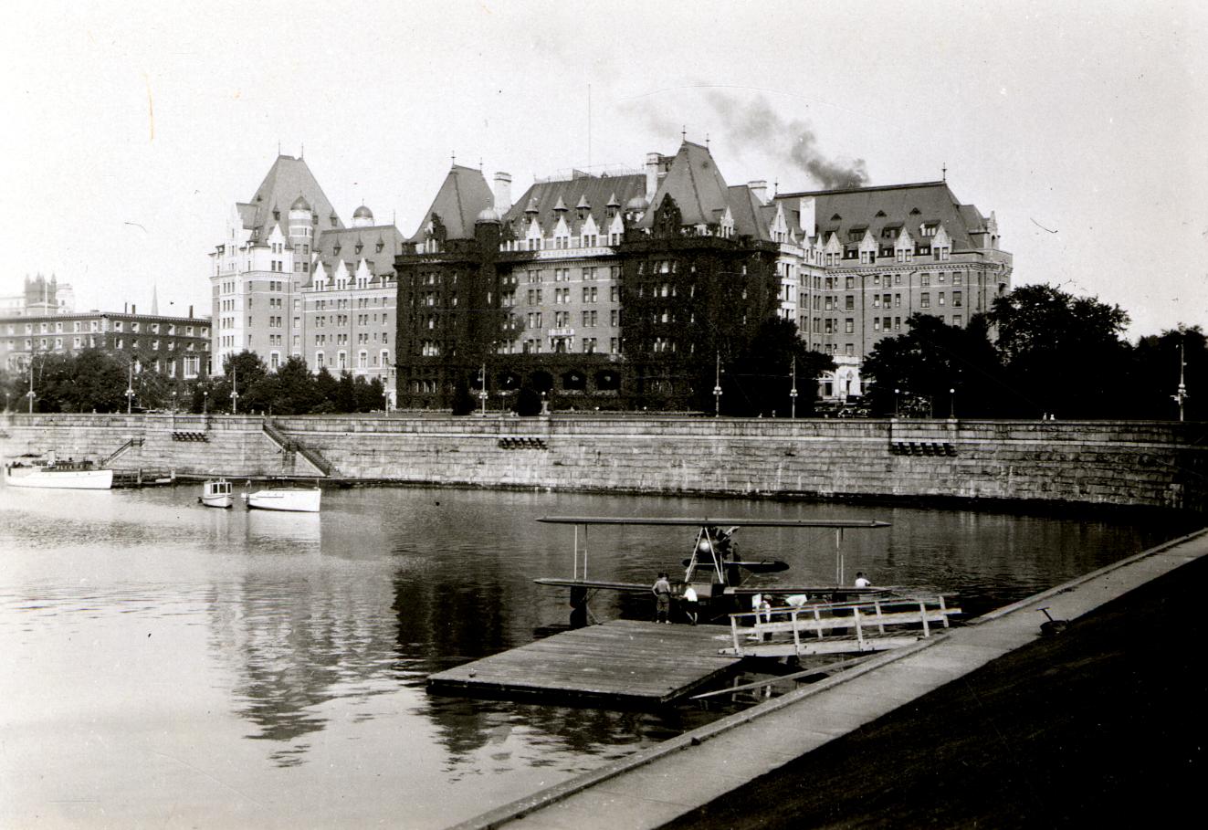 a body of water with a dock and a building in the background
