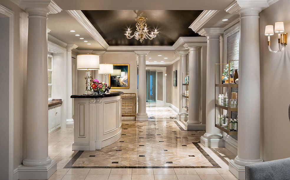 a room with a chandelier and shelves