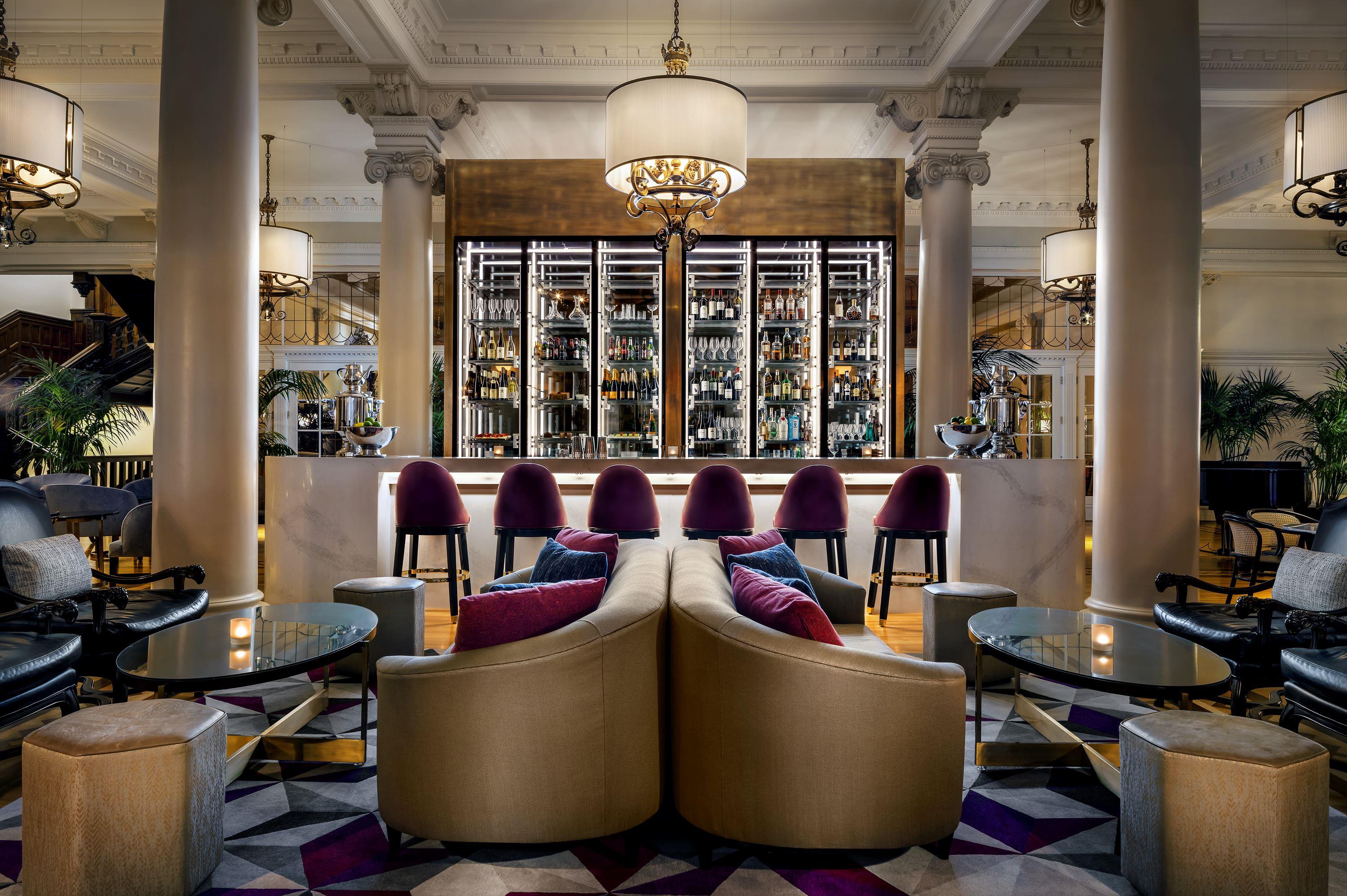 a room with a bar and chairs