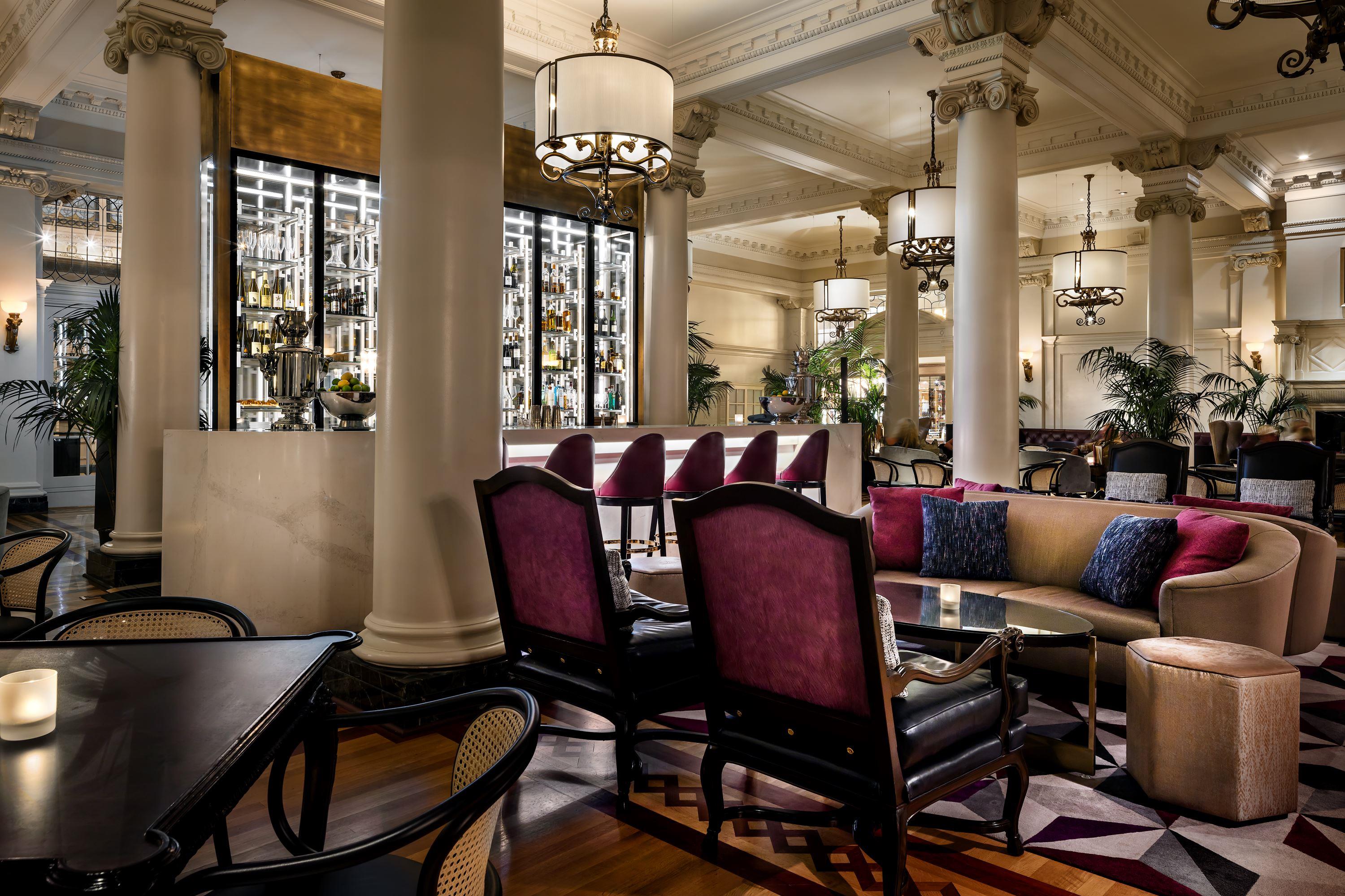 a room with a large column and a table and chairs