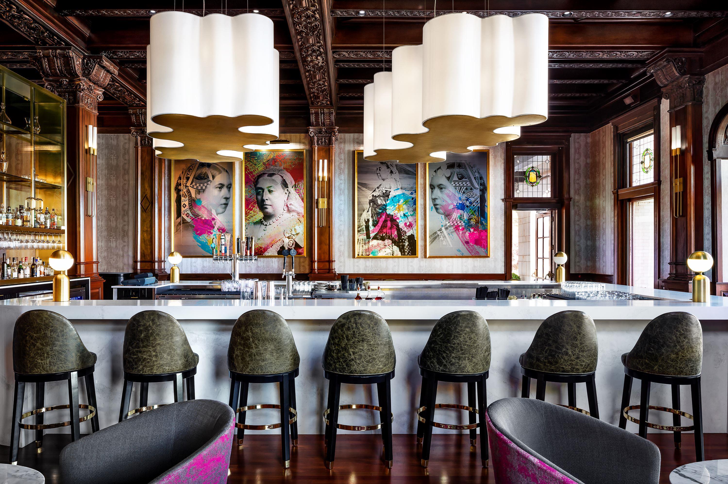 a bar with chairs and a bar counter
