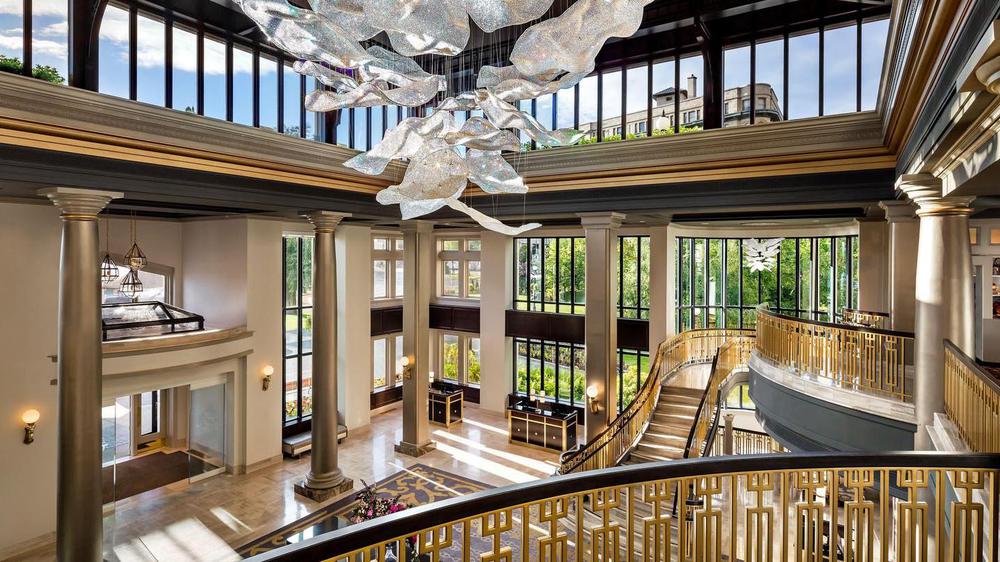 a large building with a staircase and a chandelier