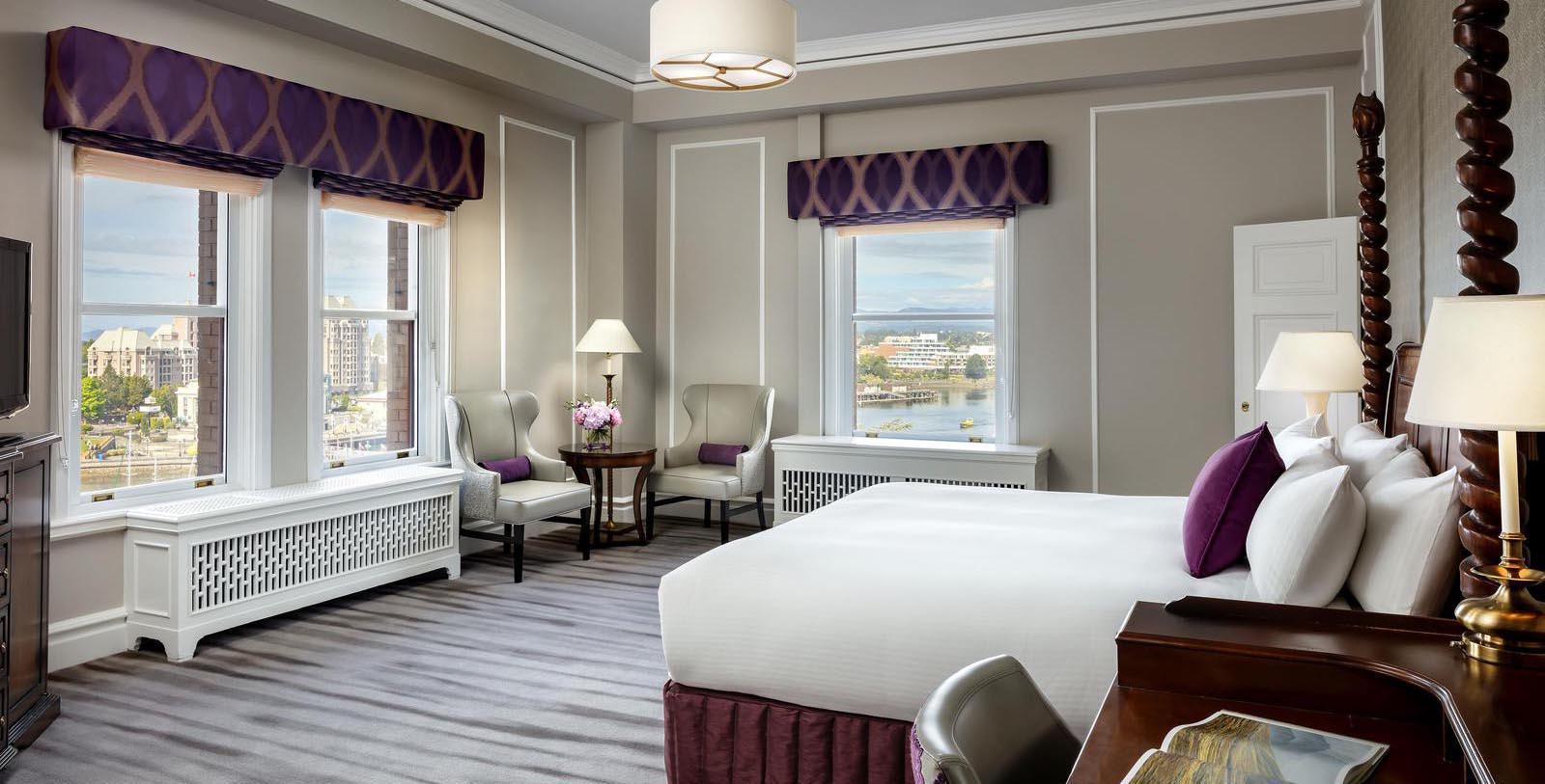 a room with a bed and chairs